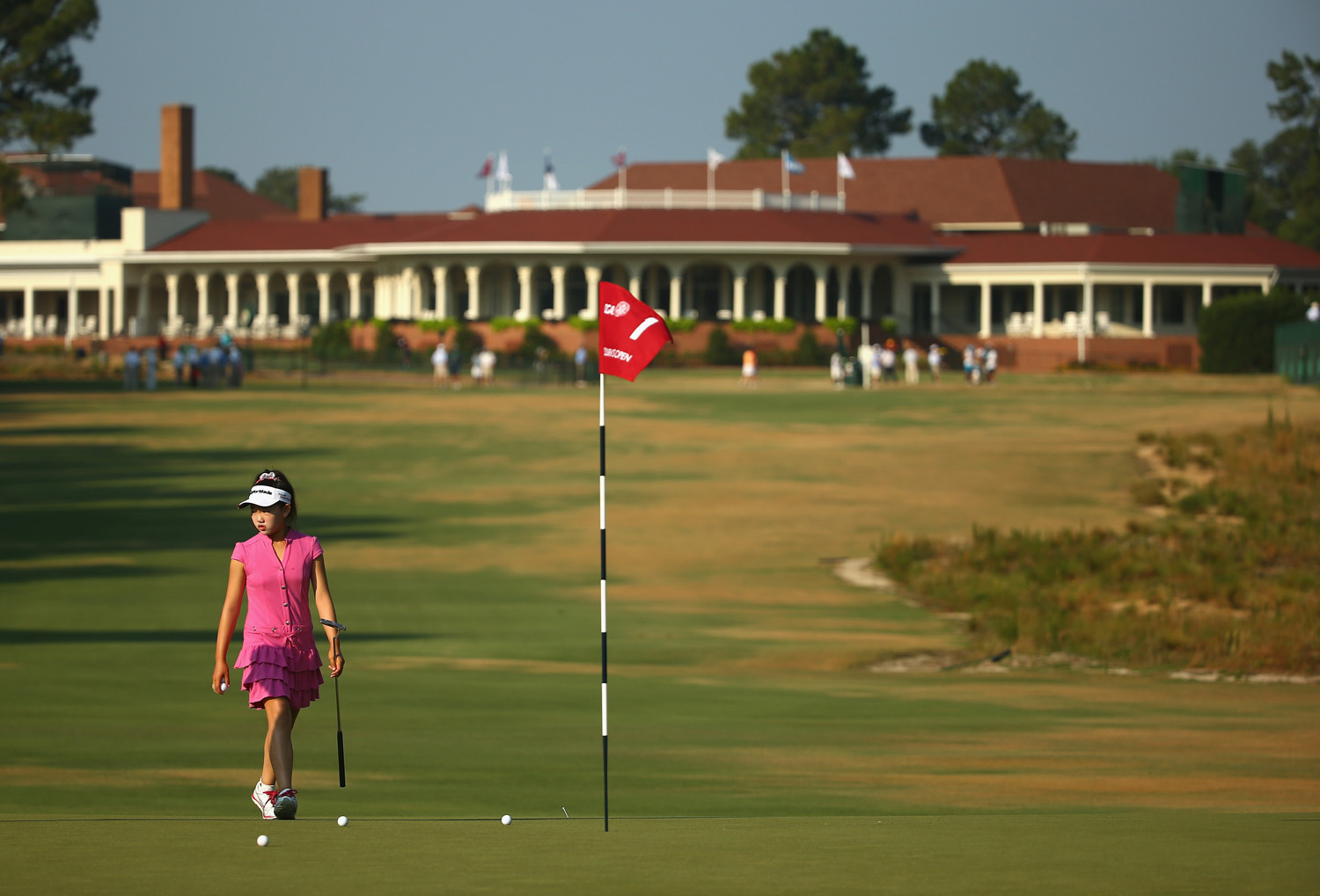 Eleven-year old Amateur Lucy Li of the United States walks on the first green during a practice round prior to the start of the 69th U.S. Women's Open at Pinehurst Resort &amp; Country Club, Course No. 2 in Pinehurst, N.C. on June 18, 2014.