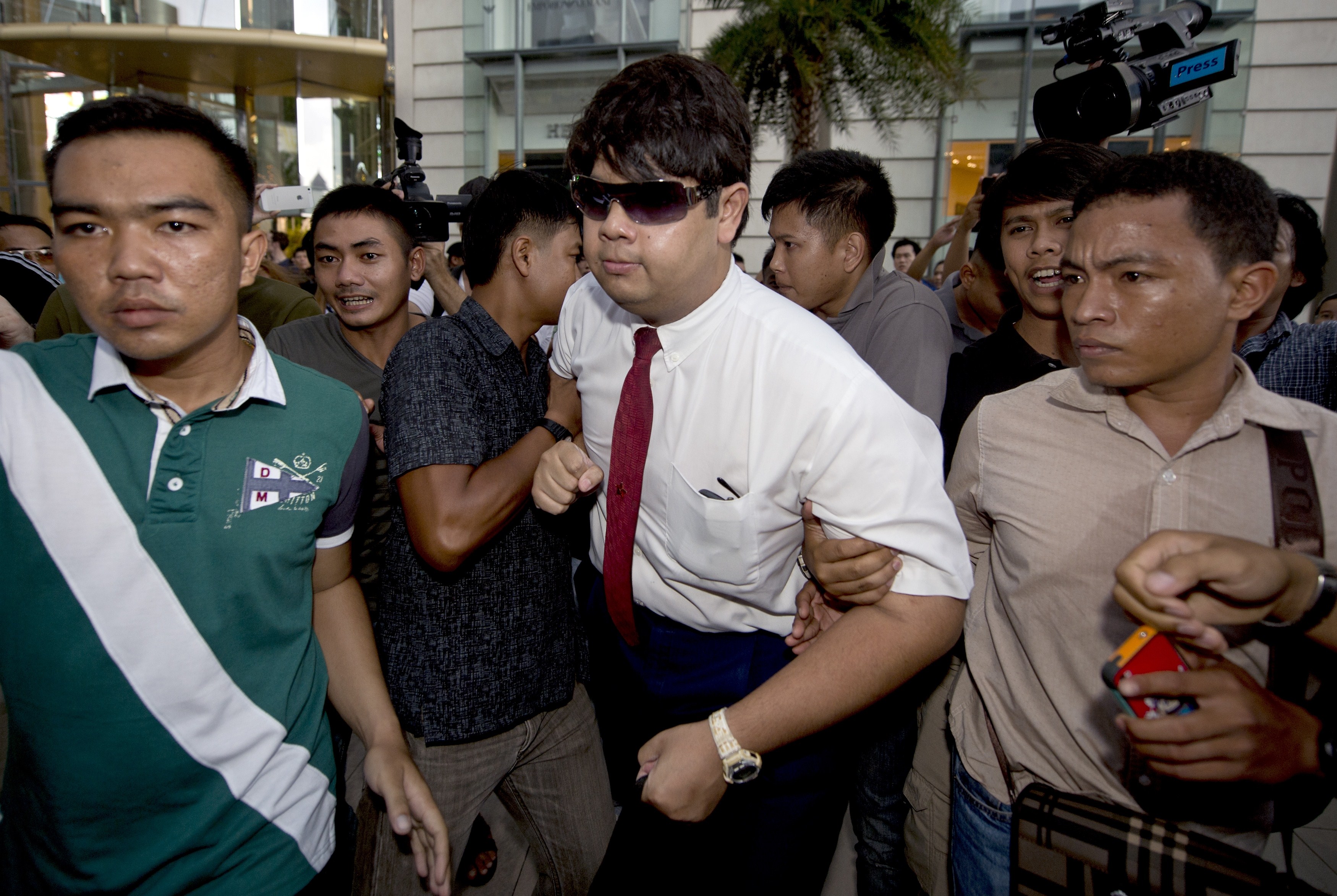 Thai policemen arrest a student for reading George Orwell's <i>1984</i> at a shopping mall in Bangkok on June 22, 2014 (Pornchai Kittiwongsakul—AFP/Getty Images)