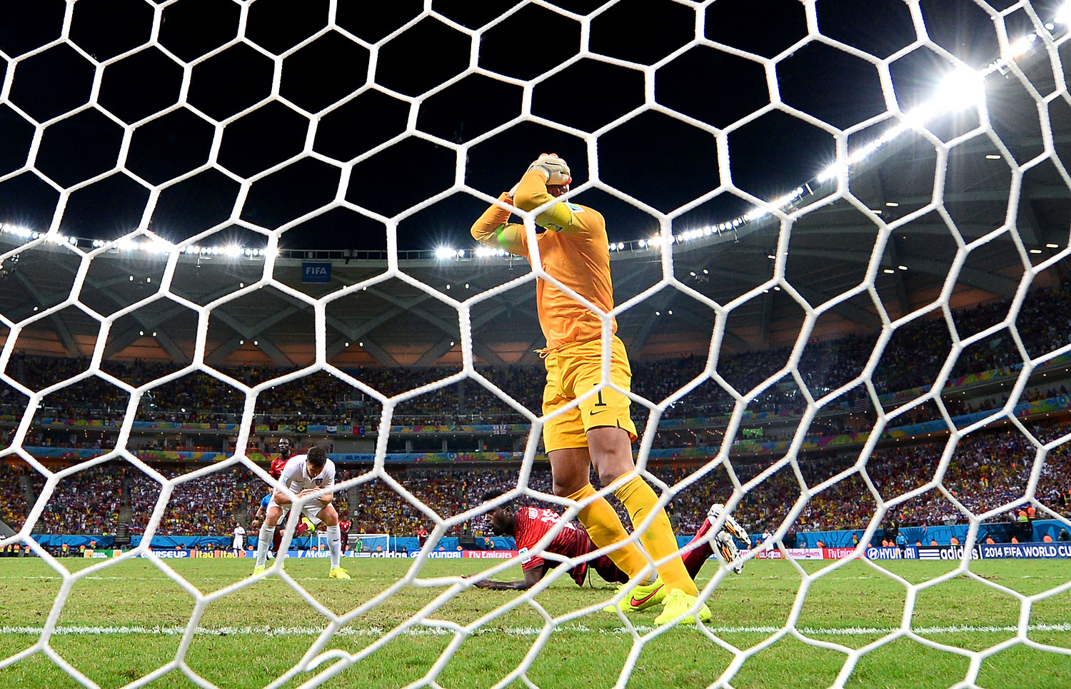 Silvestre Varela of Portugal scores the team's second goal past Tim Howard of the United States.