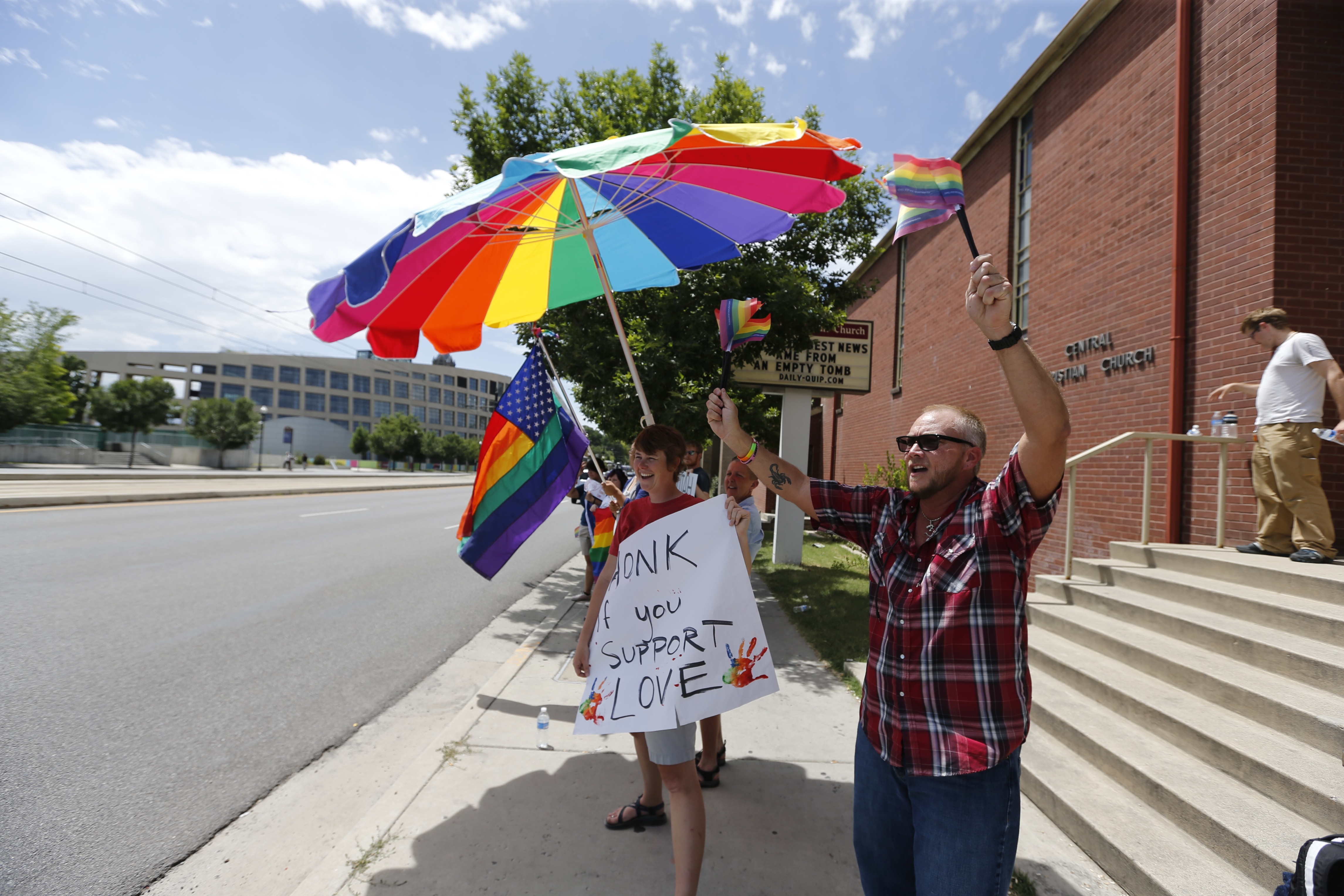Dayne Law (R) and several others wave flags and cheer outside the Utah Pride Center after the 10th Circuit Court in Denver ruled and upheld same sex marriage in Utah on June 25, 2014 in Salt Lake City, Utah. (George Frey&mdash;Getty Images)