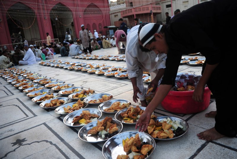 A Pakistani Muslim man arranges Iftar food for Muslim devotees before they break their fast during the holy fasting month of Ramadan in Karachi on June 30, 2014.