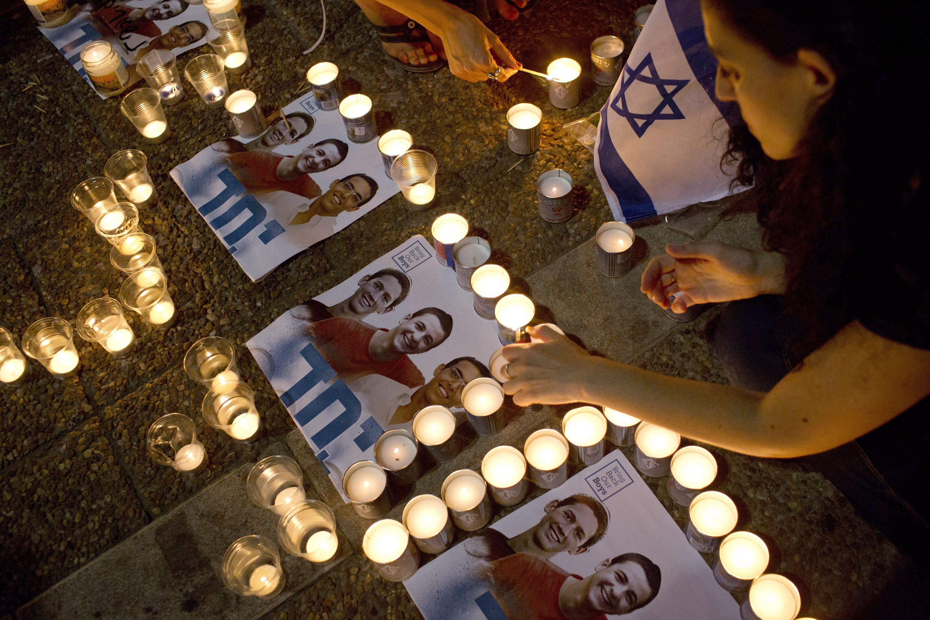 Israelis mourns and light candles in Rabin Square in Tel Aviv on June 30, 2014, after the announcement that the bodies of the three missing Israeli teenagers were found (Oren Ziv—AFP/Getty Images)