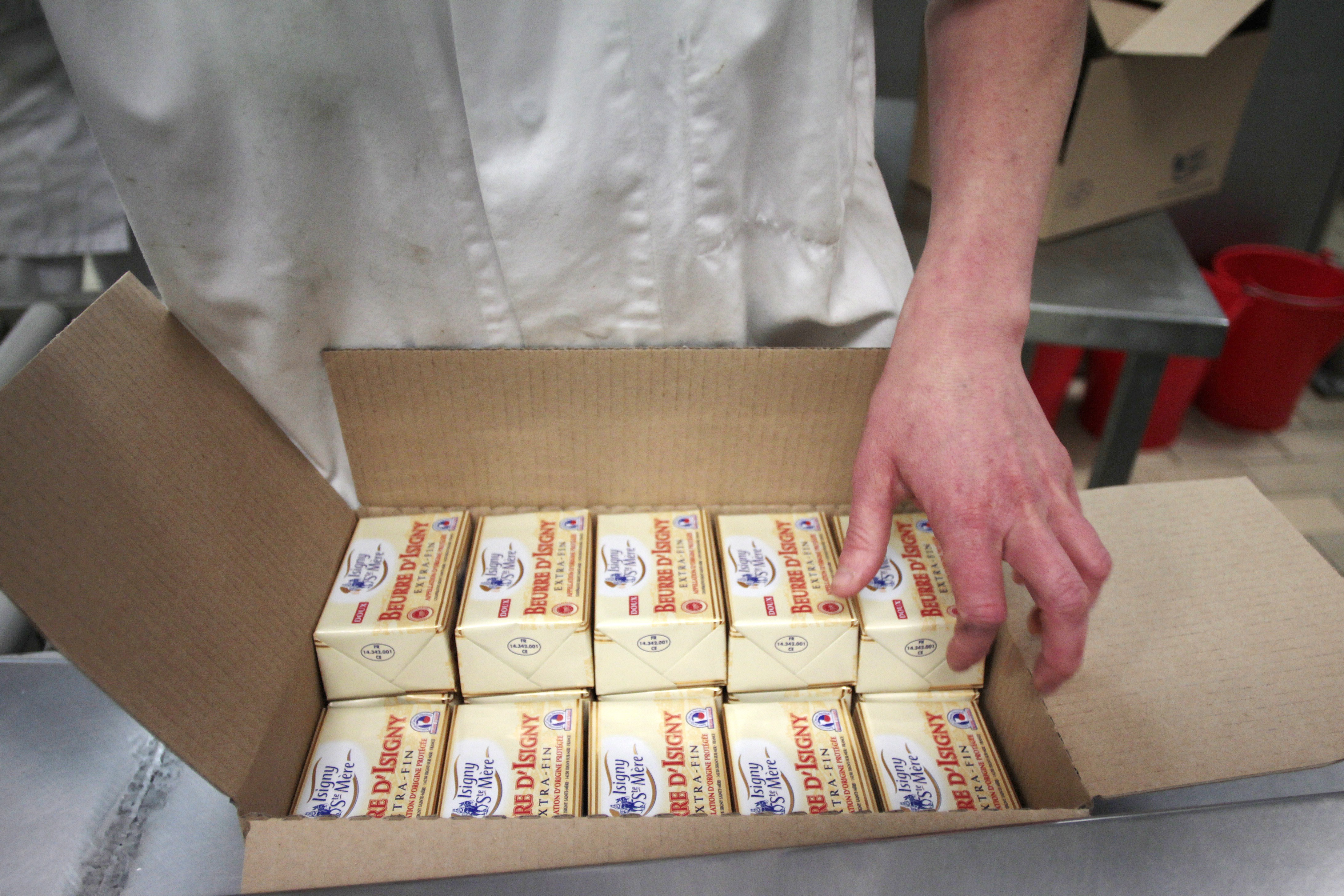 A worker packs butter at the production site of the Isigny-Sainte-Mere dairy co-operative in Isigny-sur-Mer, northwestern France, on April 4, 2014. (CHARLY TRIBALLEAU—AFP/Getty Images)