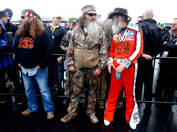 Willie, Phil and Si Robertson of Duck Dynasty take part in pre-race ceremonies for the NASCAR Sprint Cup Series Duck Commander 500 at Texas Motor Speedway on April 6, 2014 in Fort Worth, Texas. (Jonathan Ferrey—Getty Images)