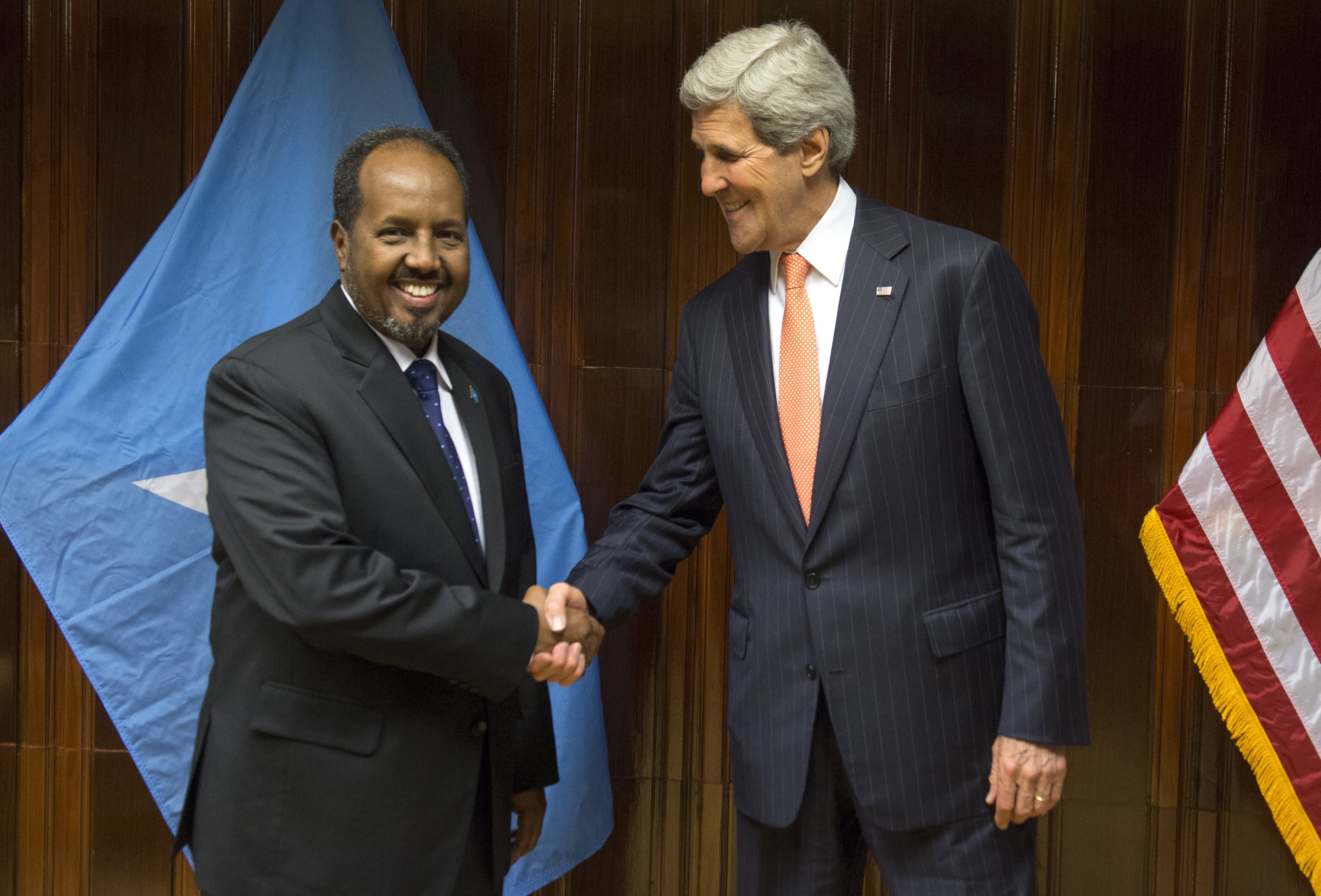 US Secretary of State John Kerry (R) and Somali President Hassan Sheikh Mohamud shake hands prior to a meeting at Addis Ababa Bole International Airport on May 3, 2014. (SAUL LOEB—AFP/Getty Images)