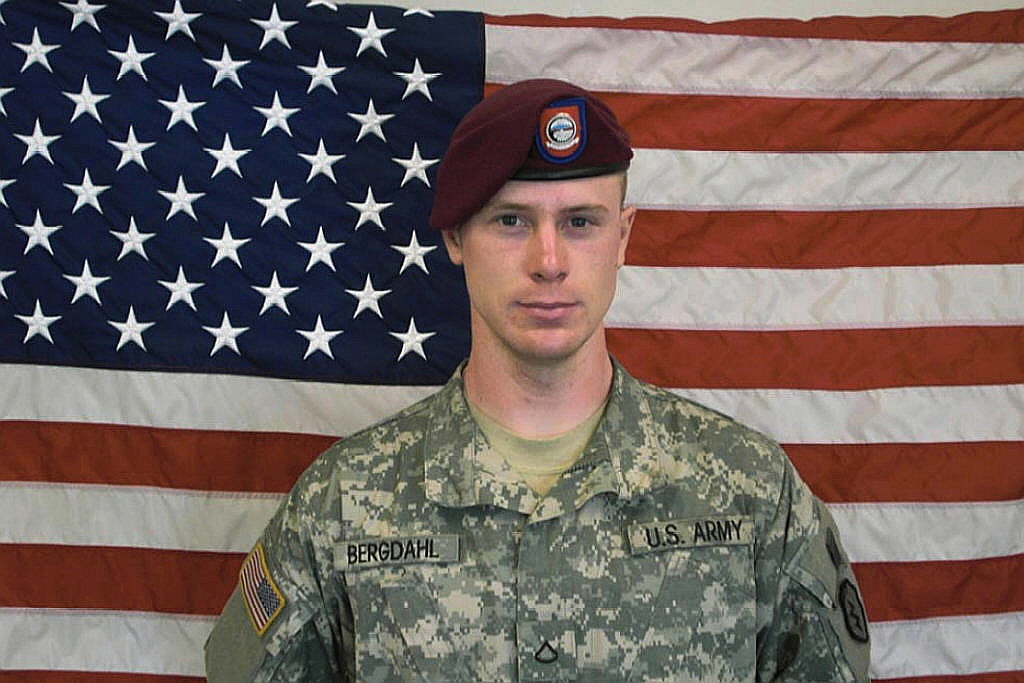 In this undated image provided by the U.S. Army, Sgt. Bowe Bergdahl poses in front of an American flag. (U.S. Army/Getty Images)