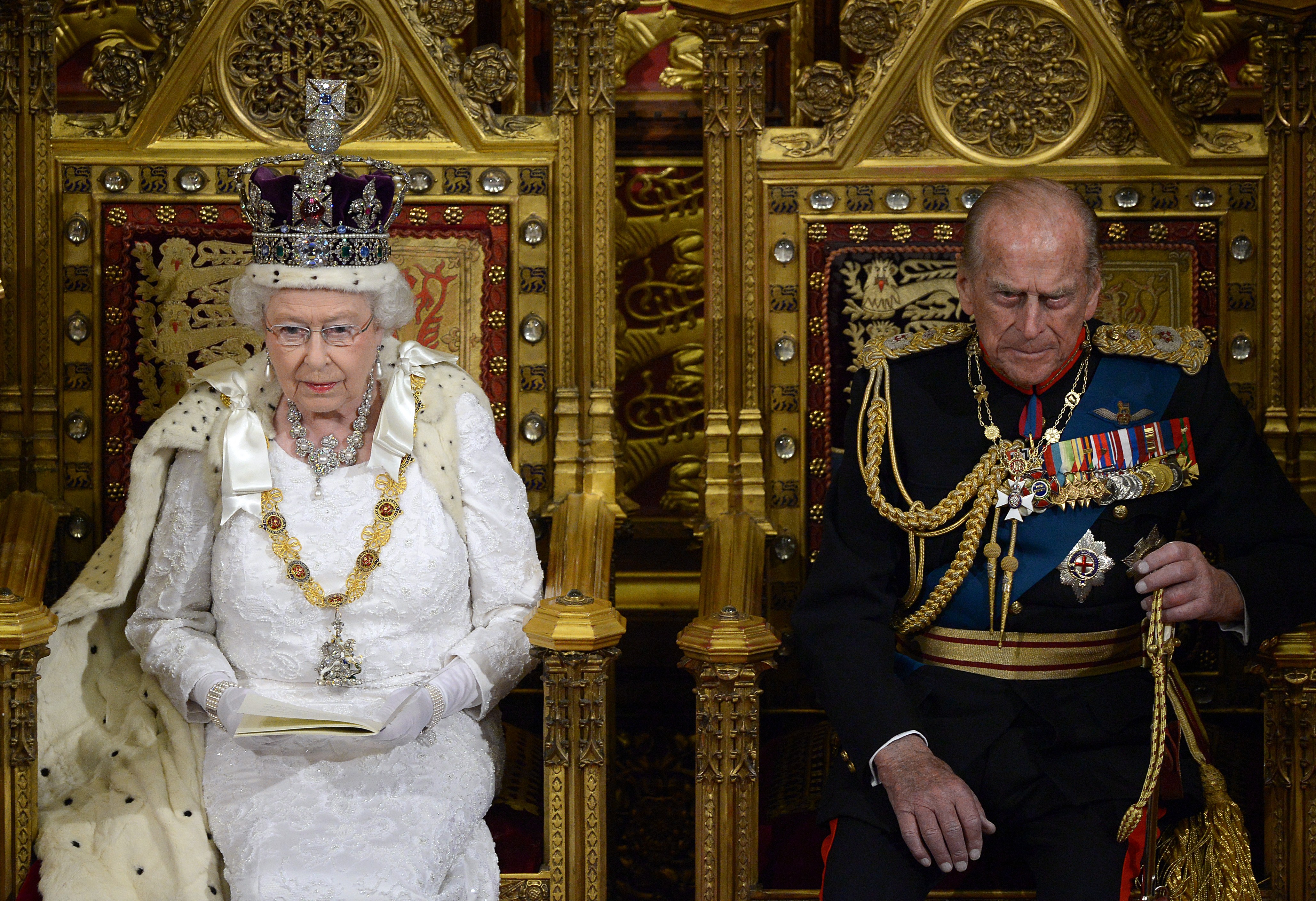 Britain's Queen Elizabeth II (L) delivers the Queen's Speech from the Throne in the House of Lords next to Prince Philip, Duke of Edinburgh (R) during the State Opening of Parliament (CARL COURT—AFP/Getty Images)