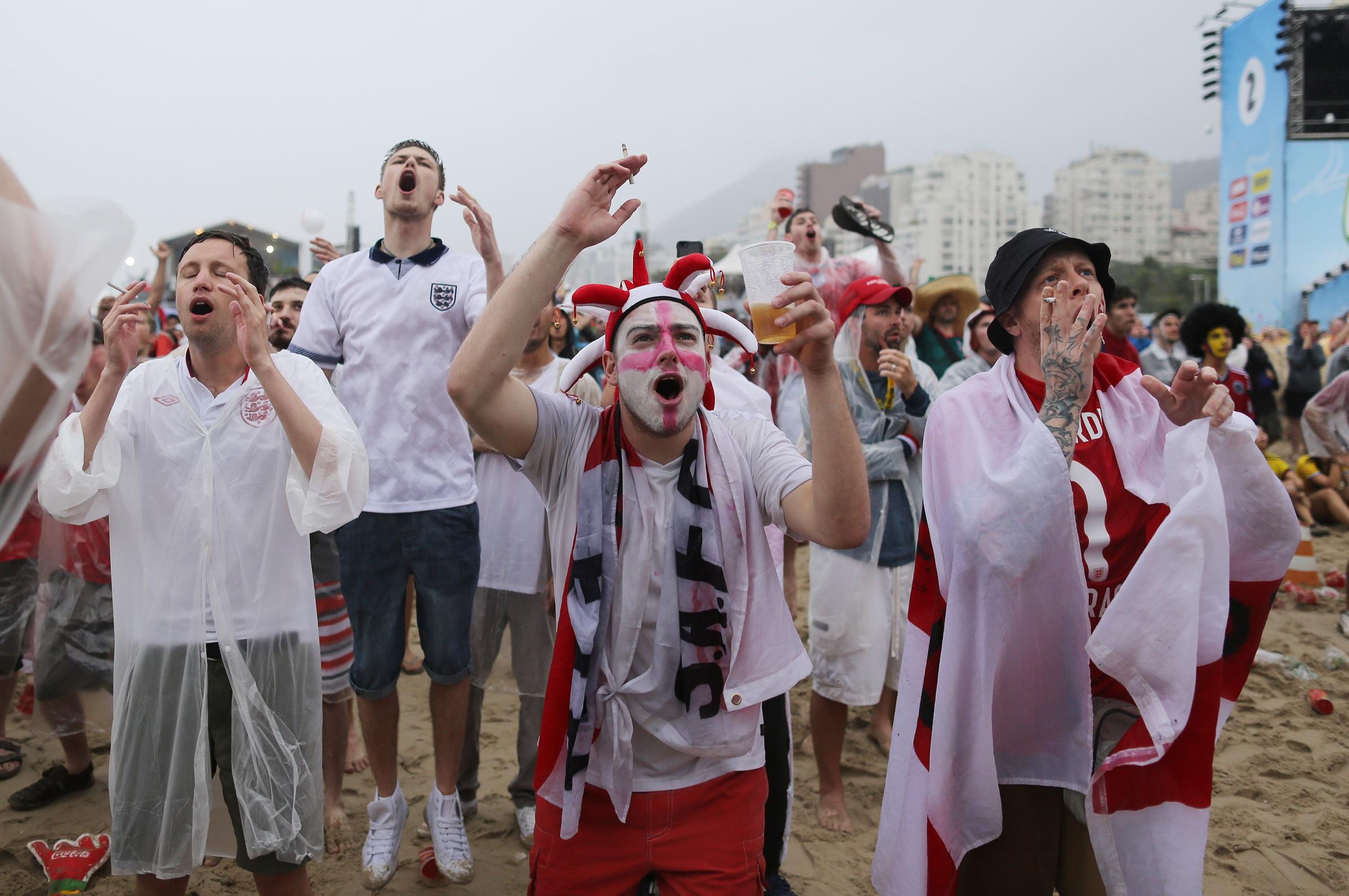 England fans react as they watch a live telecast of the group D World Cup match between Uruguay and England, inside the FIFA Fan Fest area on Copacabana beach, in Rio de Janeiro on June 19, 2014.