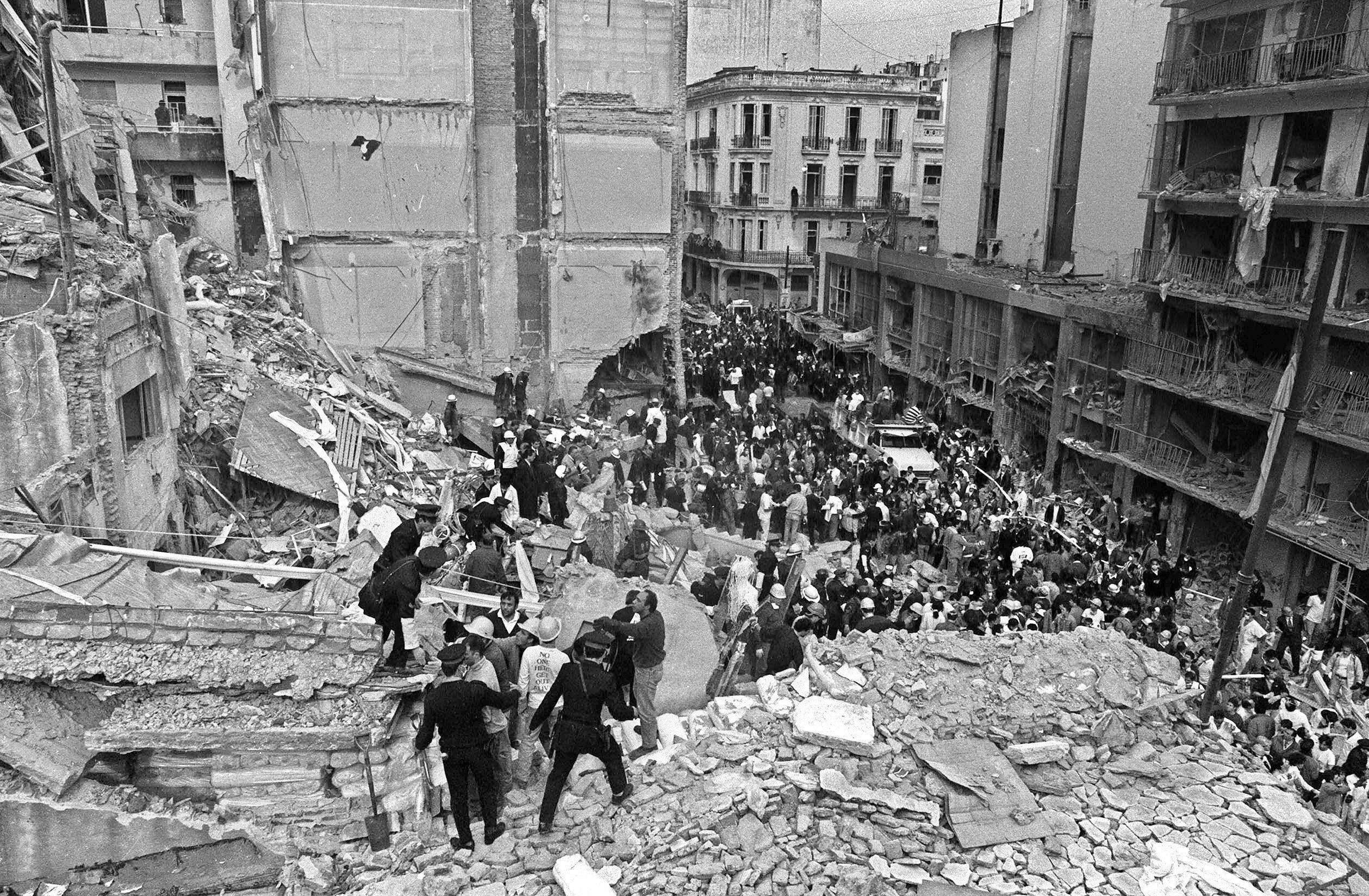 Firemen and policemen search for wounded people after a bomb exploded at the Argentine-Israeli Mutual Association community center in Buenos Aires on July 18, 1994. (ALI BURAFI&mdash;AFP/Getty Images)