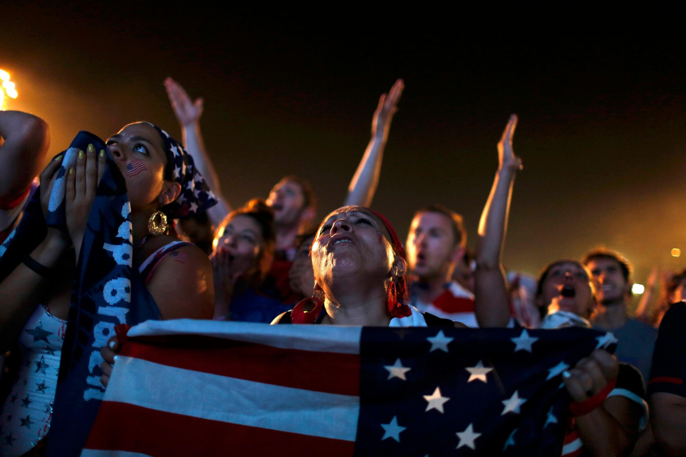 U.S. fans react as they watch the 2014 World Cup soccer match between U.S. and Ghana on a large screen at Copacabana beach in Rio de Janeiro on June 16, 2014.