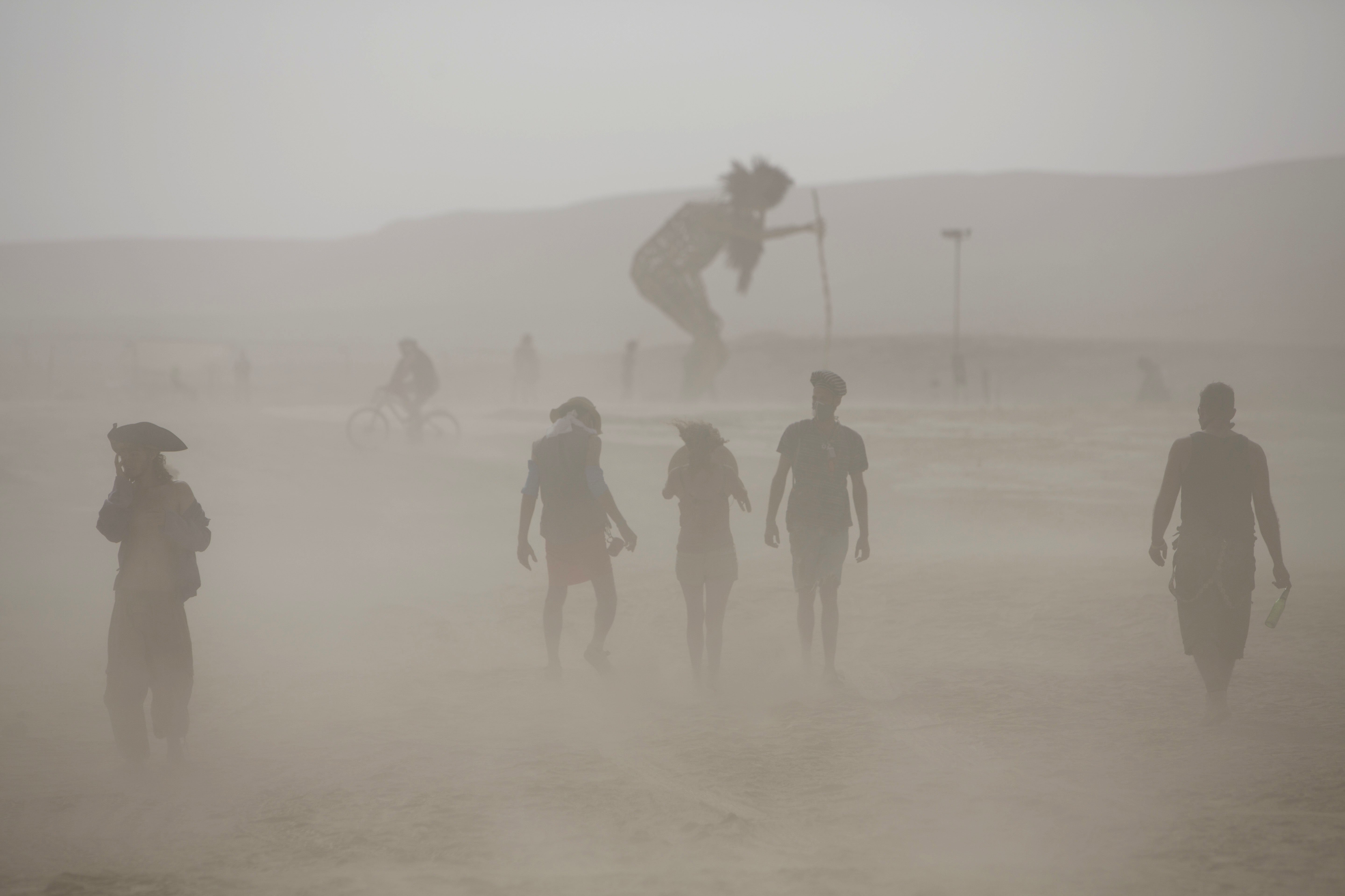 People walk in the dusty playa in the Negev Desert, Israel on June 5, 2014.