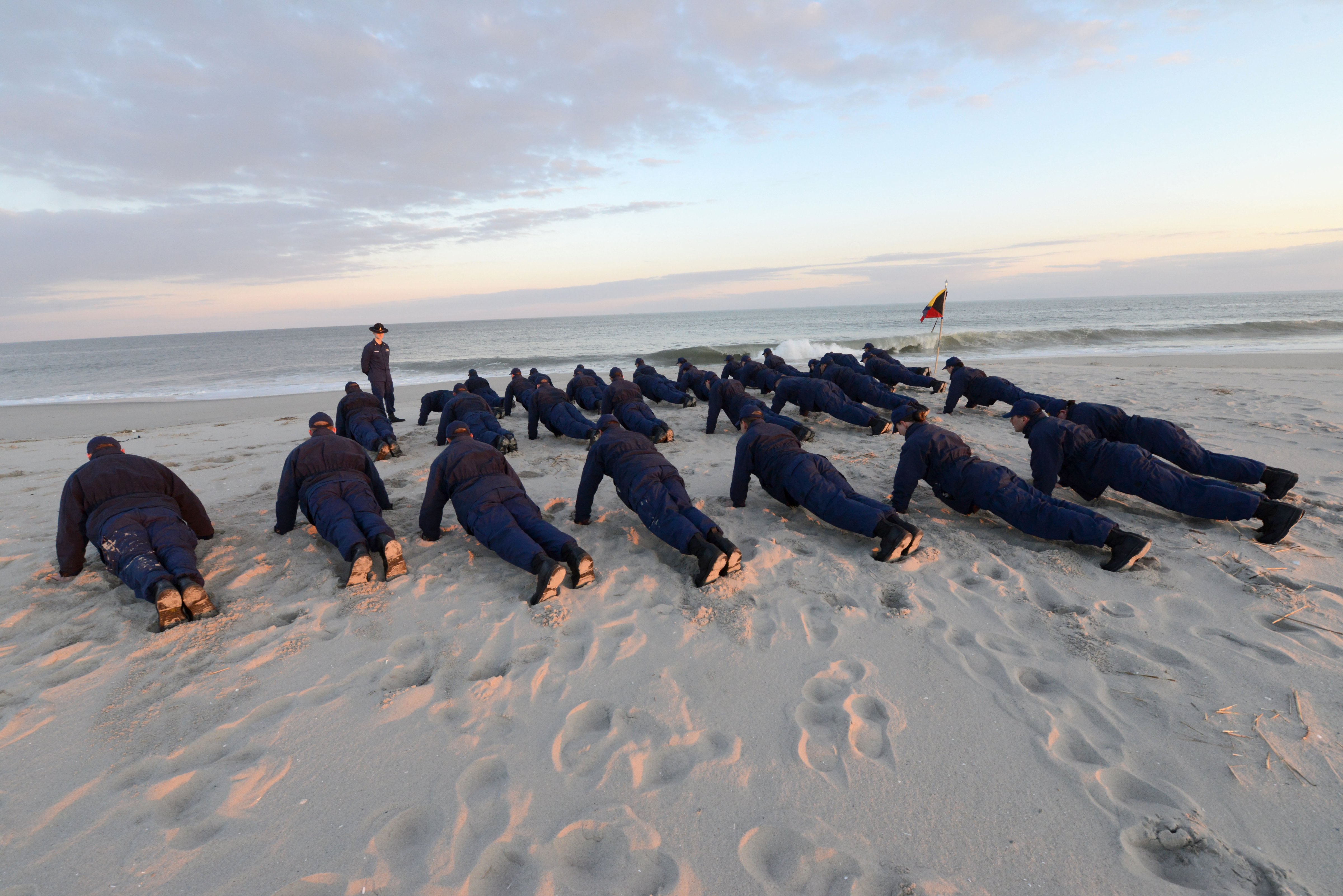Recruits at the Coast Guard's boot camp in Cape May, N.J., do pushups on the beach. (Chief Warrant Officer Donnie Brzuska / Coast Guard)