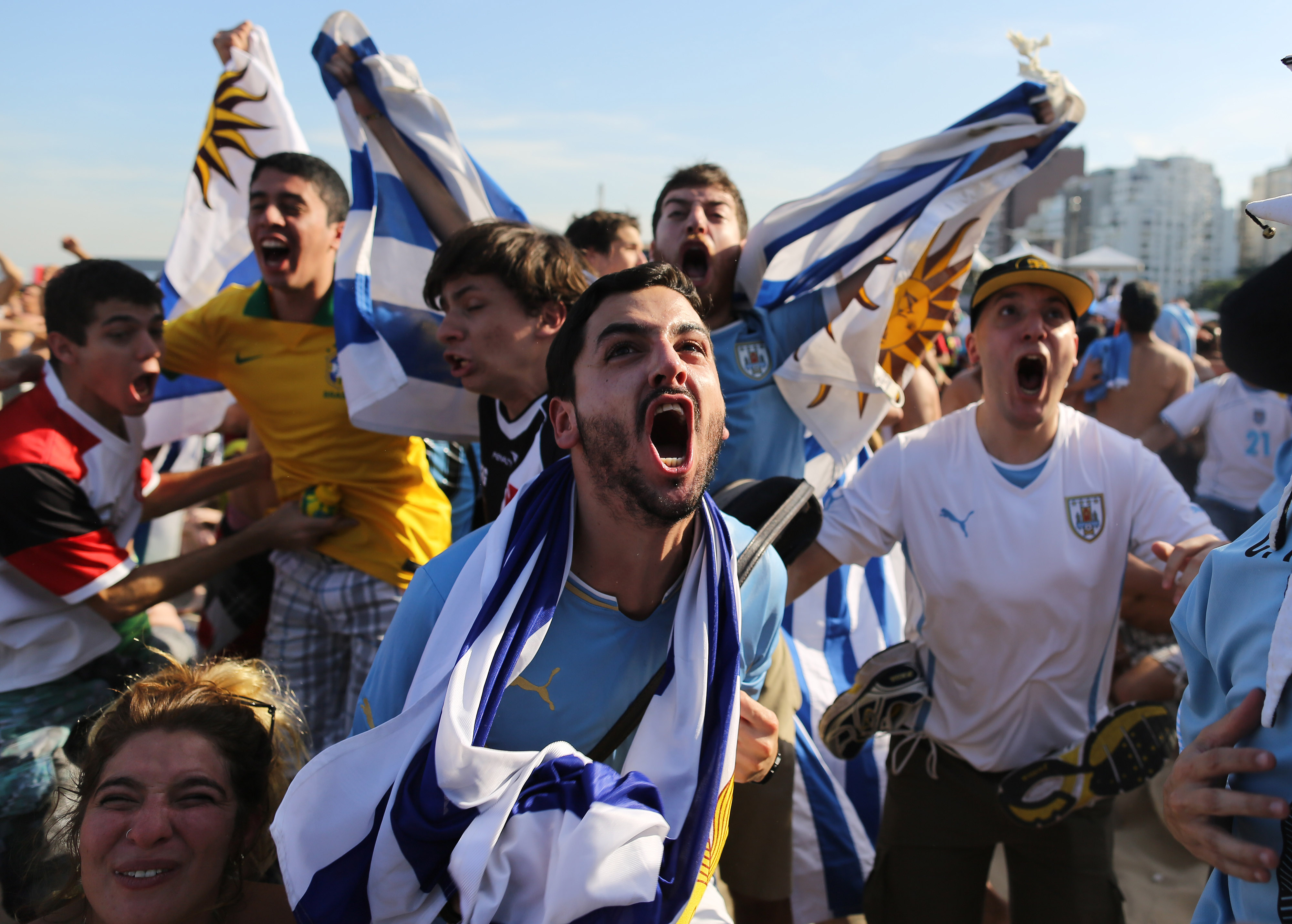 Uruguay fans celebrate their team's goal against Italy as they watch the game on a live telecast inside the FIFA Fan Fest area on Copacabana beach in Rio de Janeiro on June 24, 2014.