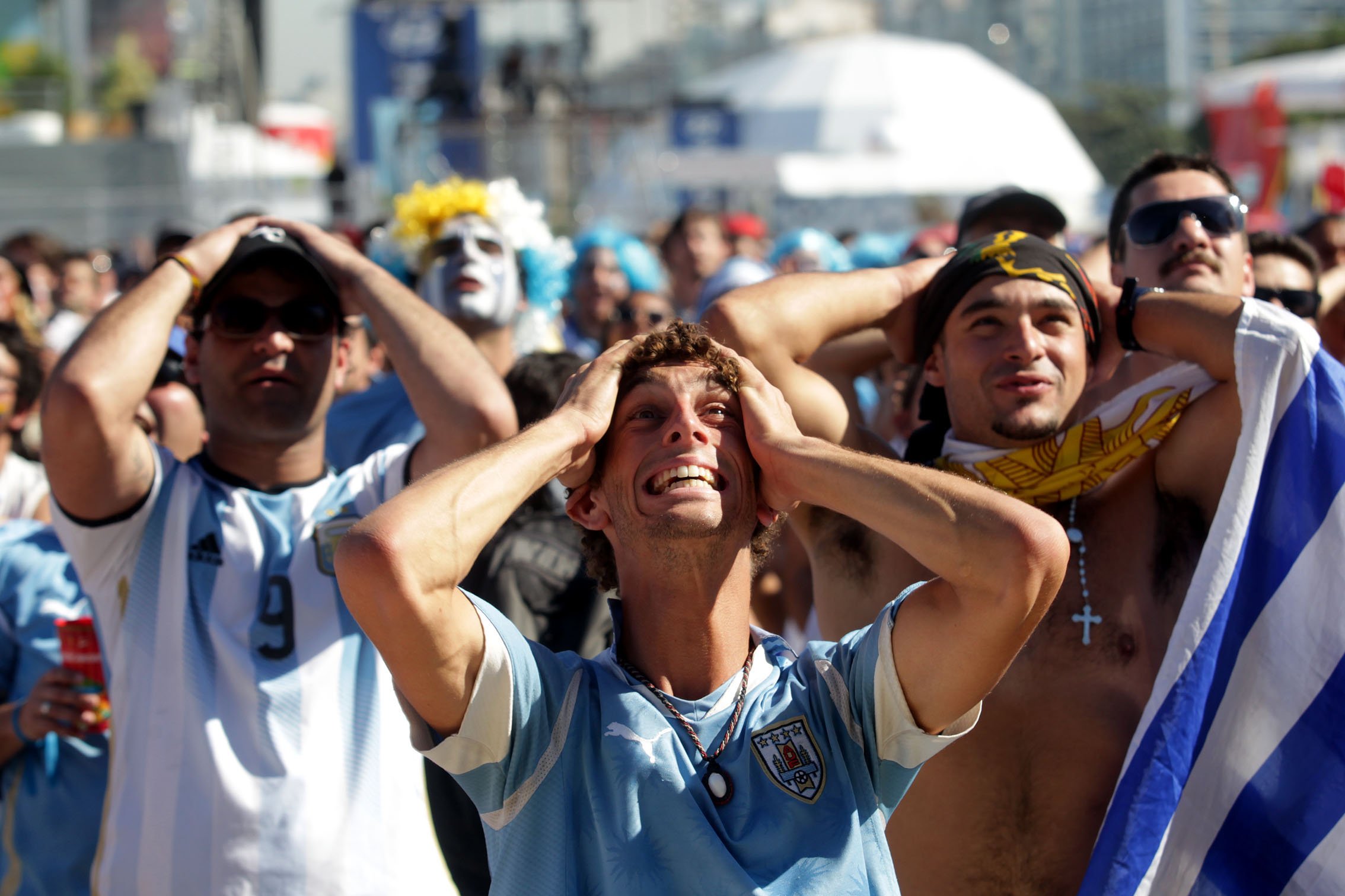 Supporters of Italy and Uruguay watch the match on the big screens of FIFA Fan Fest on the sands of Copacabana beach, Rio de Janeiro on June 24, 2014.