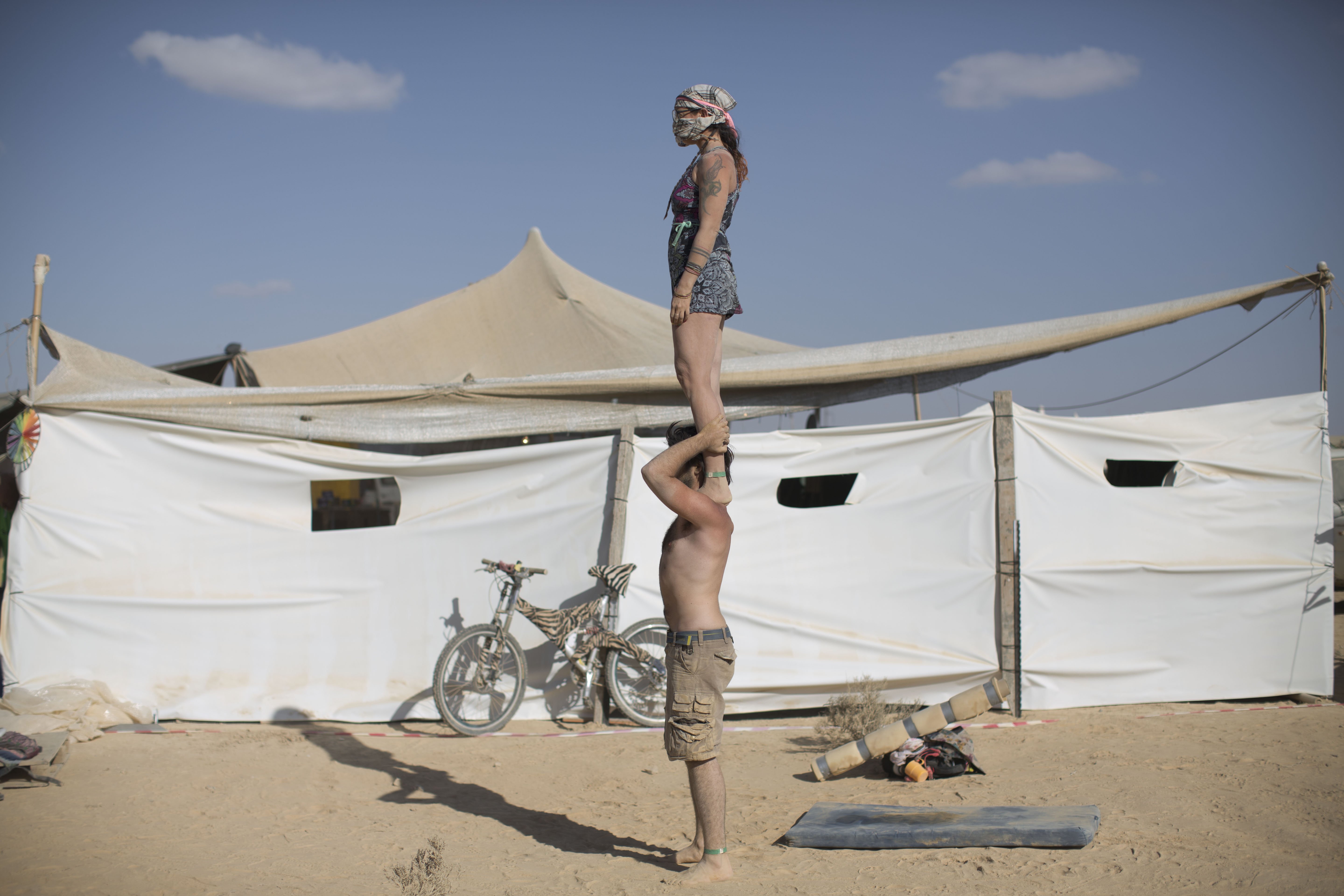 Israeli acrobats perform at Israel's first Midburn festival in the Negev Desert, Israel on June 6, 2014.