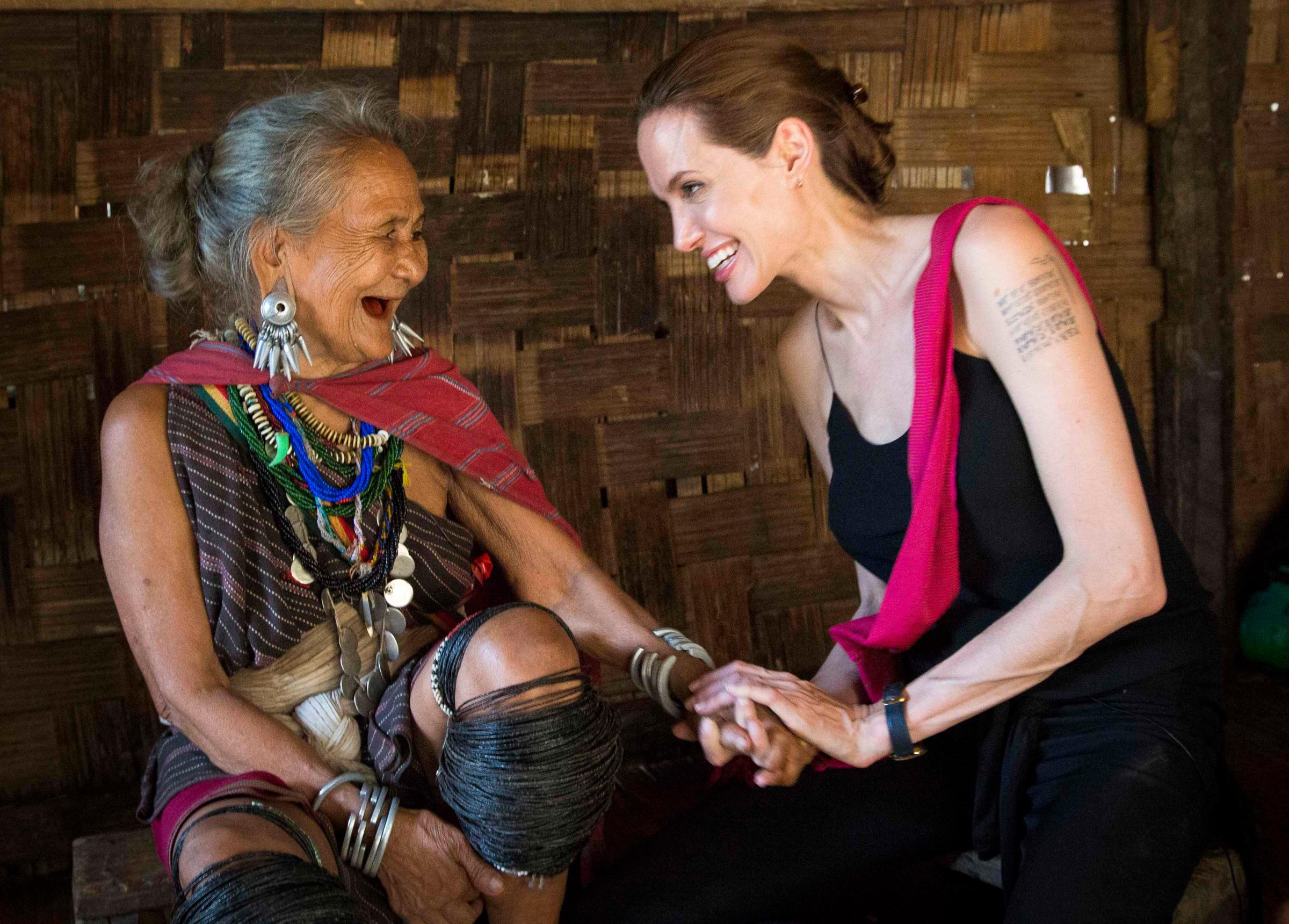 Handout photo shows Angelina Jolie, UNHCR special envoy, visiting ethnic Karenni refugee Baw Meh from Myanmar on World Refugee Day, at Ban Mai Nai Soi refugee camp in the province of Mae Hong Son