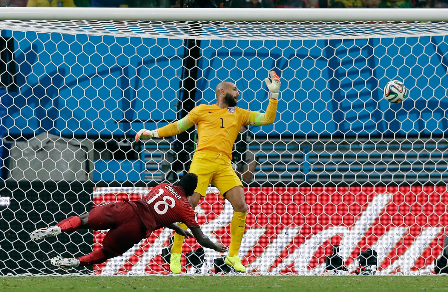 Portugal's Silvestre Varela heads the ball past United States' goalkeeper Tim Howard to score his side's second goal to tie the game 2-2.
