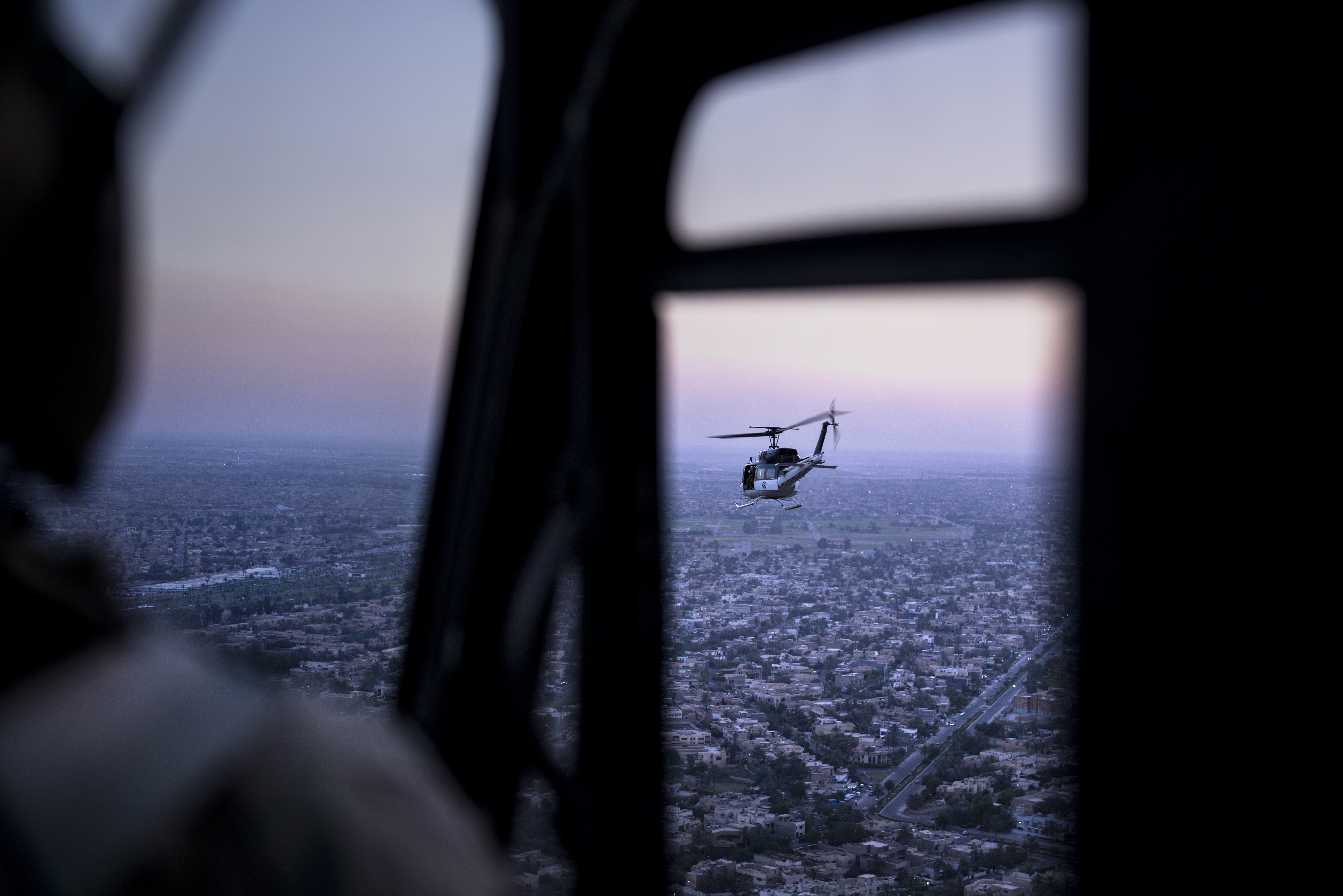 A picture taken on board a helicopter shows a US State Department helicopter flying over the Iraqi capital Baghdad as it transports US Secretary of State John Kerry on June 23, 2014, in Baghdad. (Brendan Smialowski—AFP/Getty Images)
