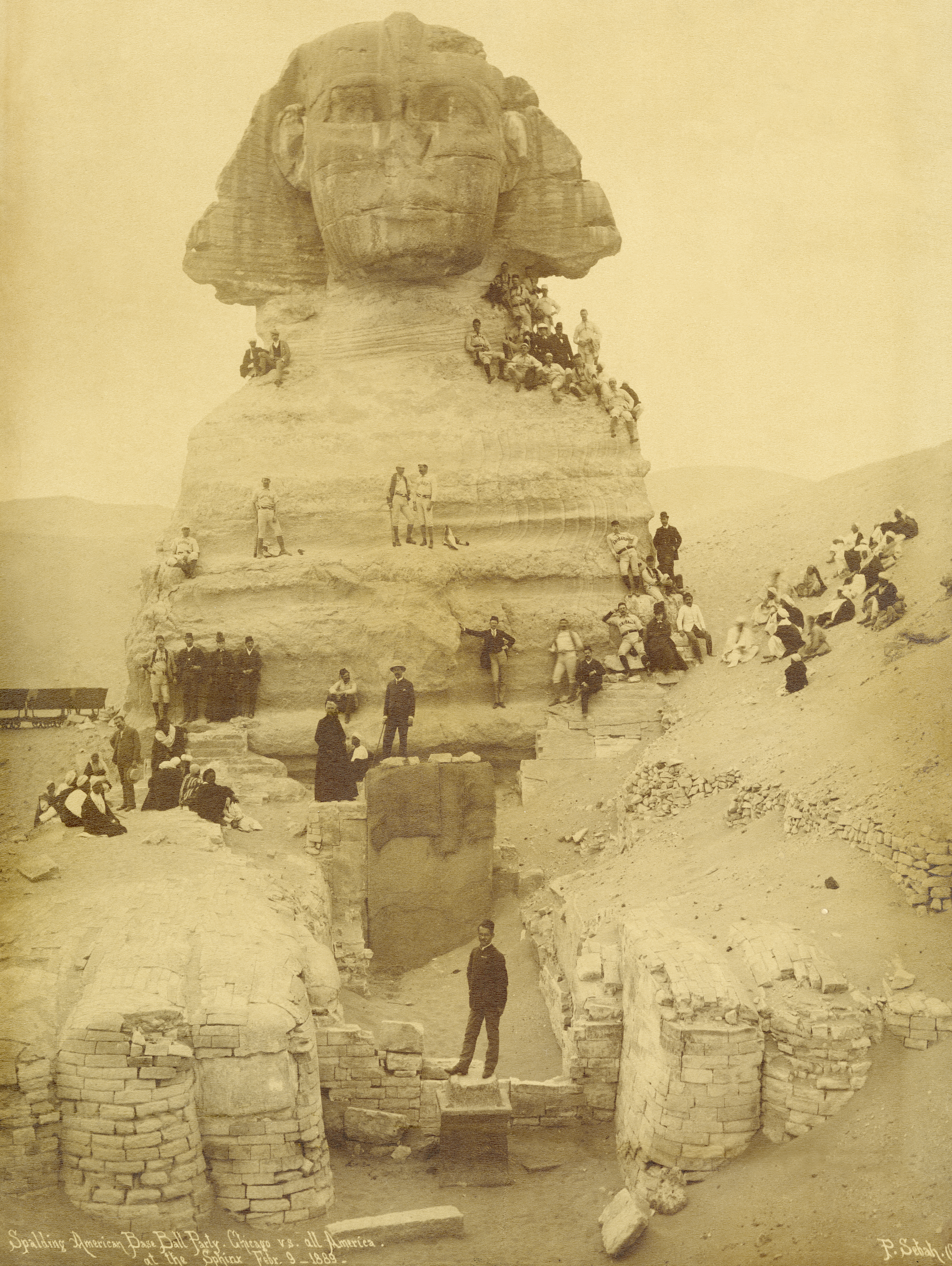 Visiting Egypt in the midst of their around-the-world ball-playing exhibition, tour organizers and baseball players climb the Sphinx for a photo, Feb. 9, 1889.