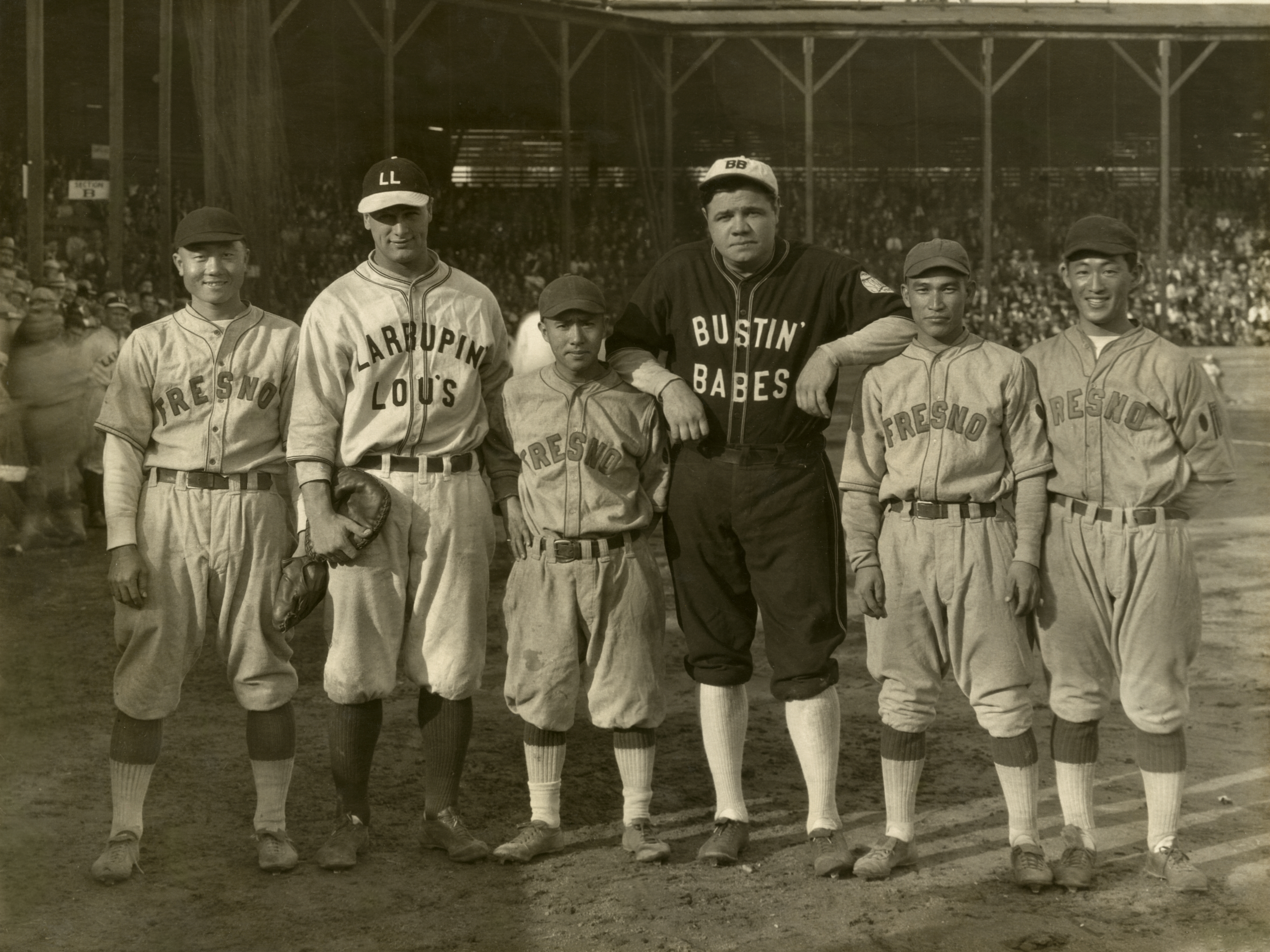 Following the 1927 World Series, Lou Gehrig and Babe Ruth barnstormed across the country, playing 21 games in just three weeks. Here the Yankees' legends loom large on either side of Kenichi Zenimura and other members of the Fresno Athletic Club at Fireman Park in Fresno, Calif., Oct. 29, 1927.
