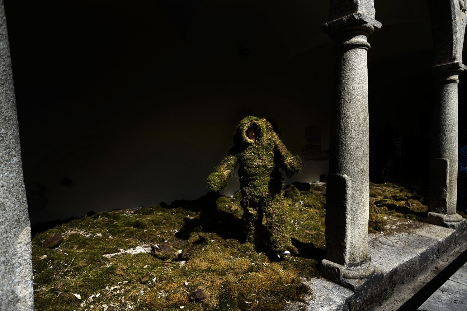 A man dressed in moss walks towards the beginning of the Moss Men procession as a part of the Corpus Christi procession in the small village of Bejar, Spain on June 22, 2014.