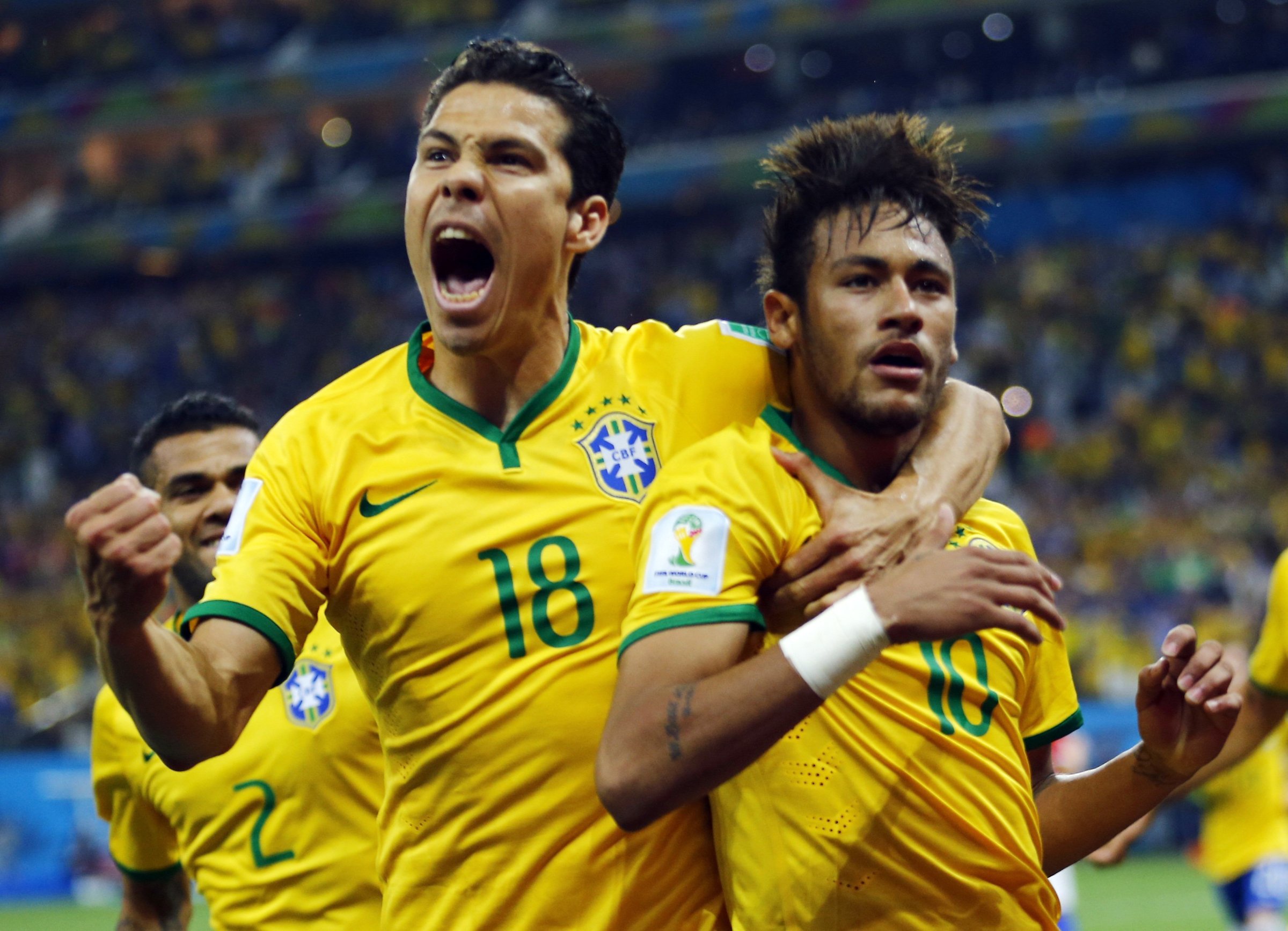 Brazil's Neymar and Hernanes celebrate after Neymar scored a goal from a penalty kick during the 2014 World Cup opening match against Croatia at the Corinthians arena in Sao Paulo