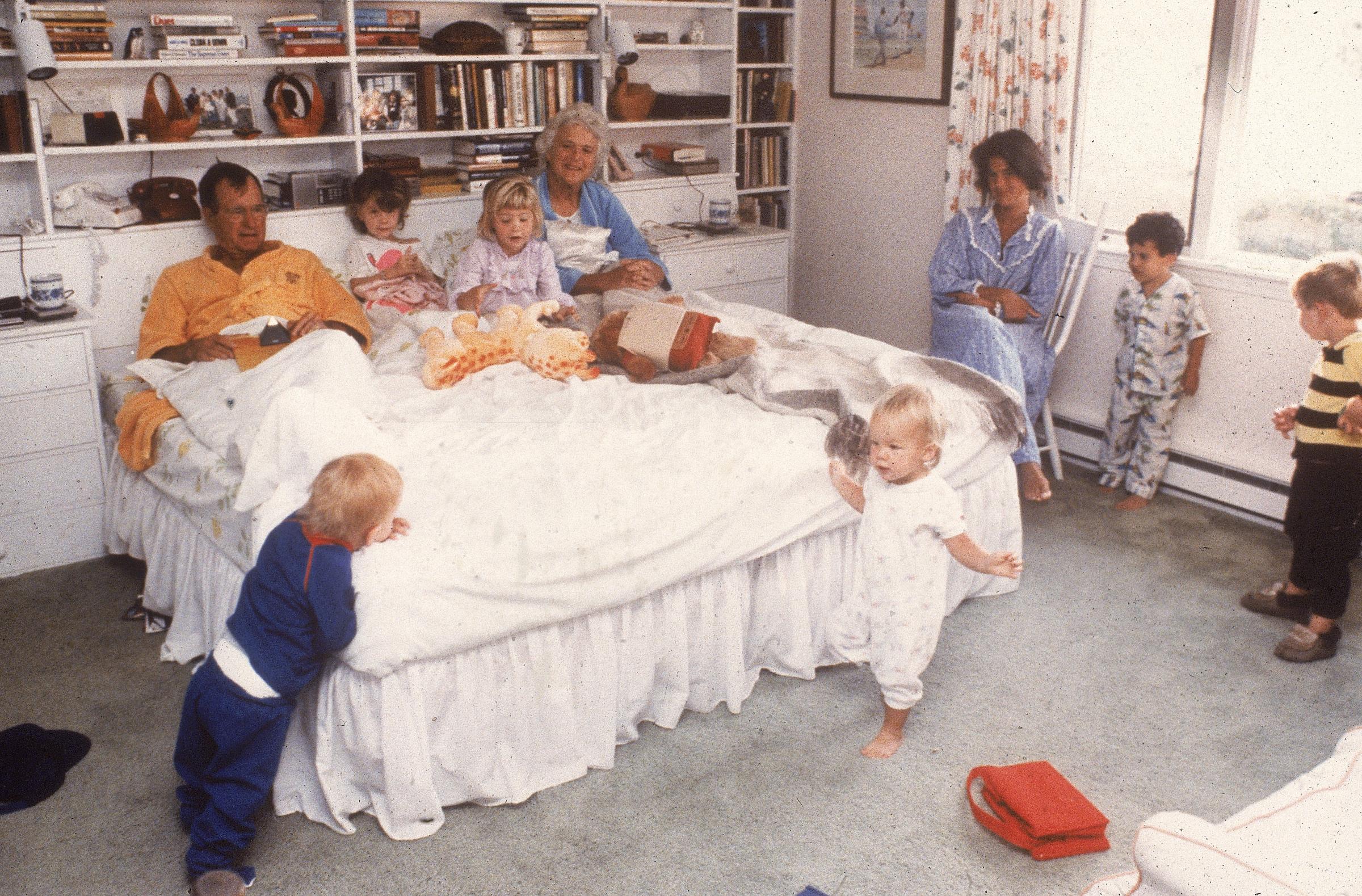 Vice president George H.W. Bush and his wife Barbara relax in bed as their daughter and grandchildren join them at home in Kennebunkport, Maine in 1987.