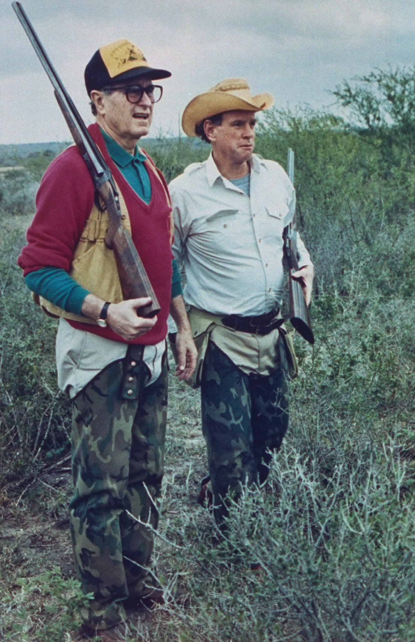 George H.W. Bush dressed in hunting gear with friend &amp; oil heir William Farish on a quail hunt at Lazy F Ranch on January 1, 1989.