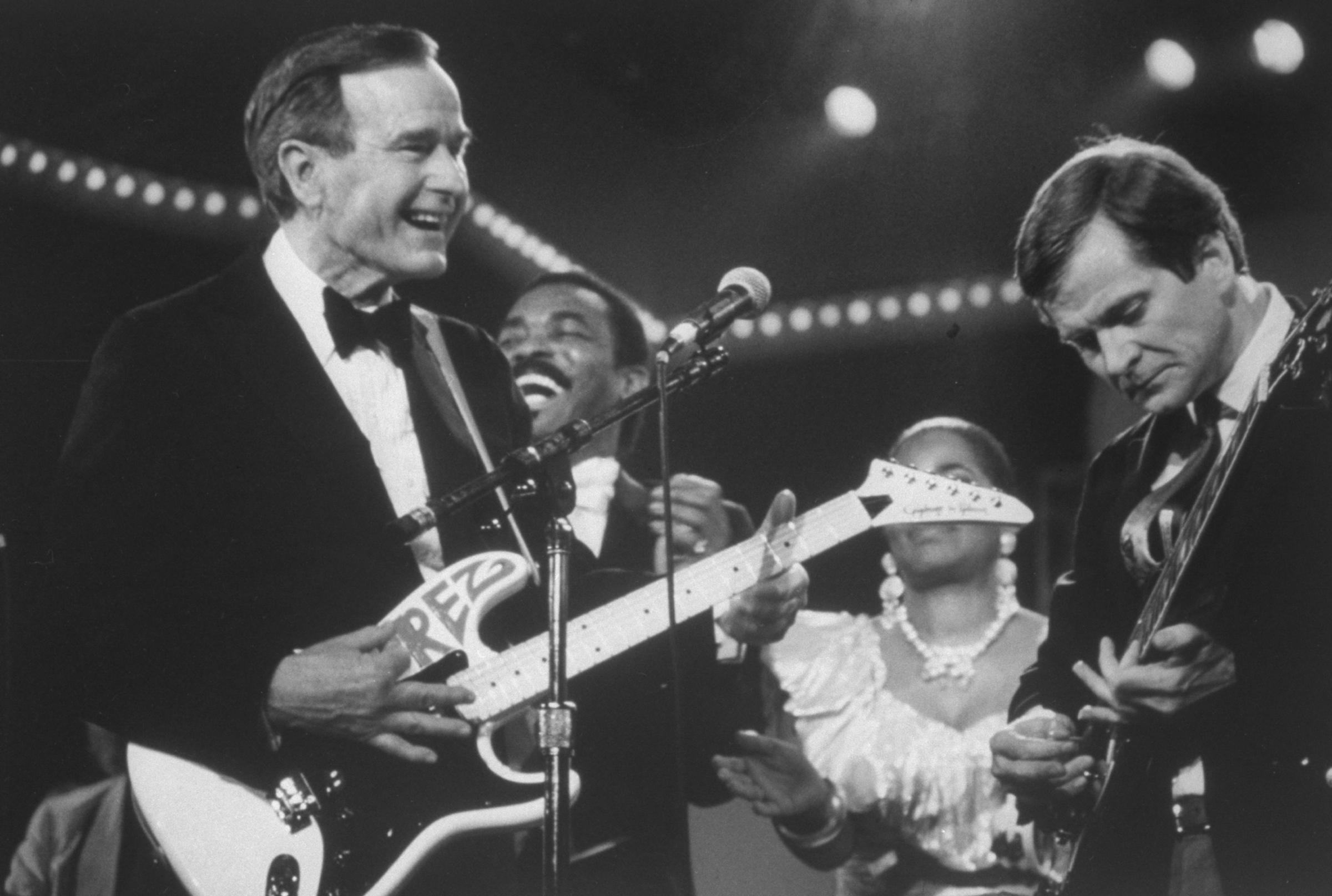 GOP Chairman Lee Atwater and President George H.W. Bush playing guitar during the inaugural weekend bash on 1989.