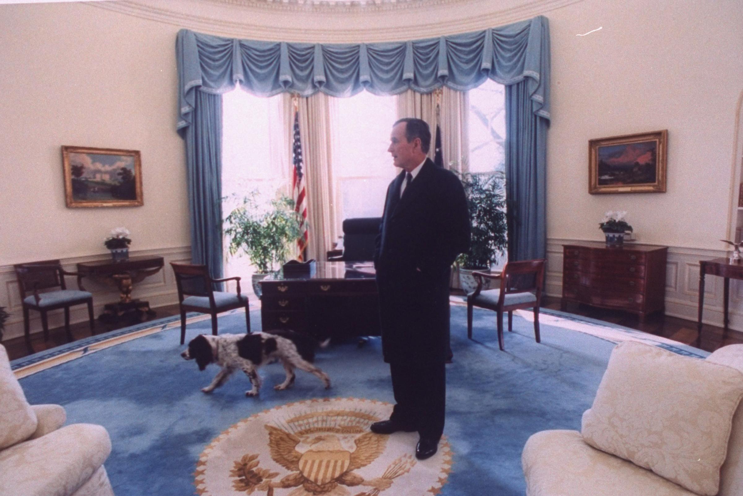 President George H.W. Bush taking a last look around the Oval Office with his dog Ranger, before vacating the White House to incoming president Bill Clinton in Washington on January 2, 1993.