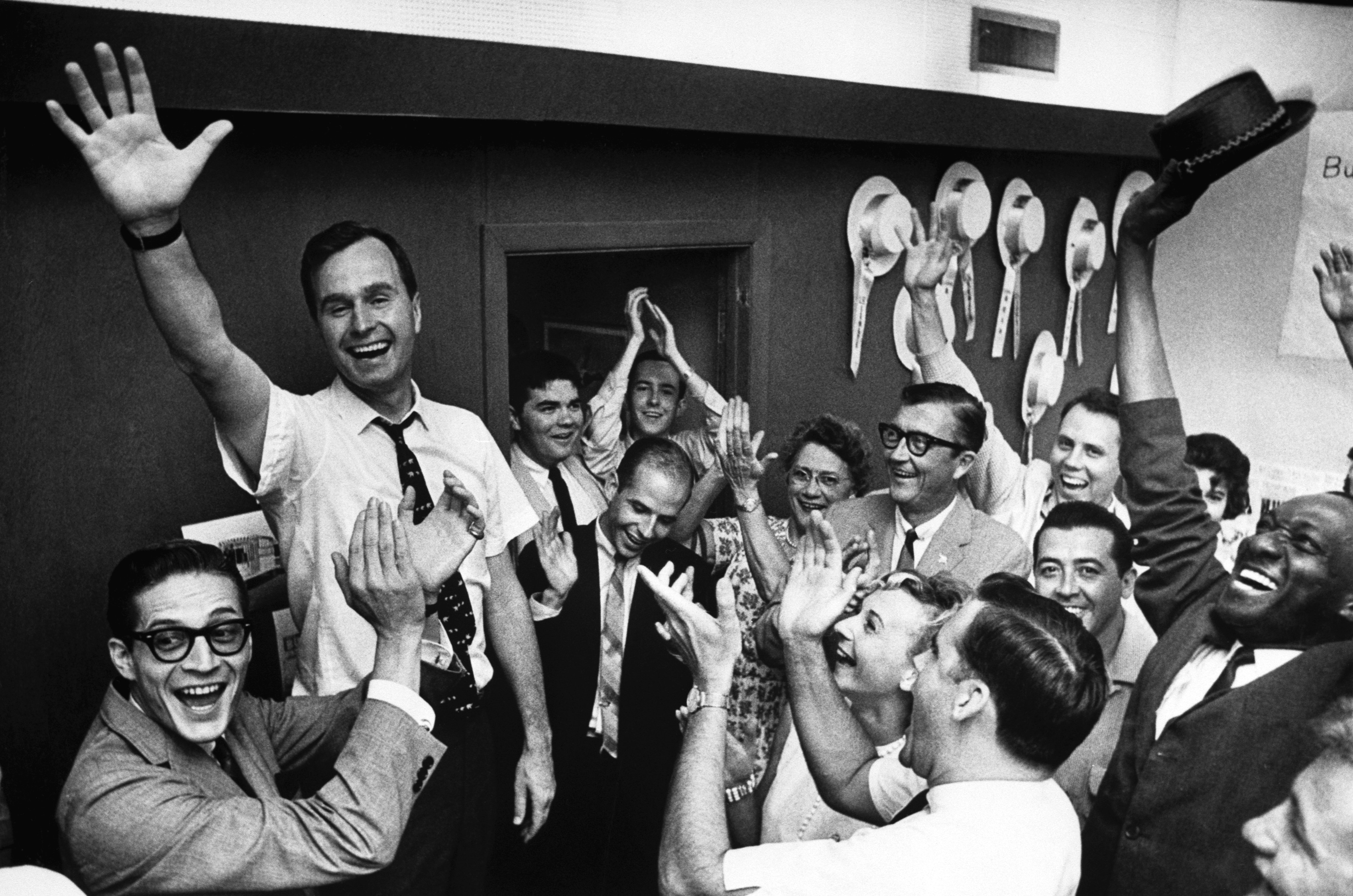 George H.W. Bush raises his arms in victory after winning an election against oilman Jack Cox for Texas Senate on June 7, 1964 in Houston, Texas.