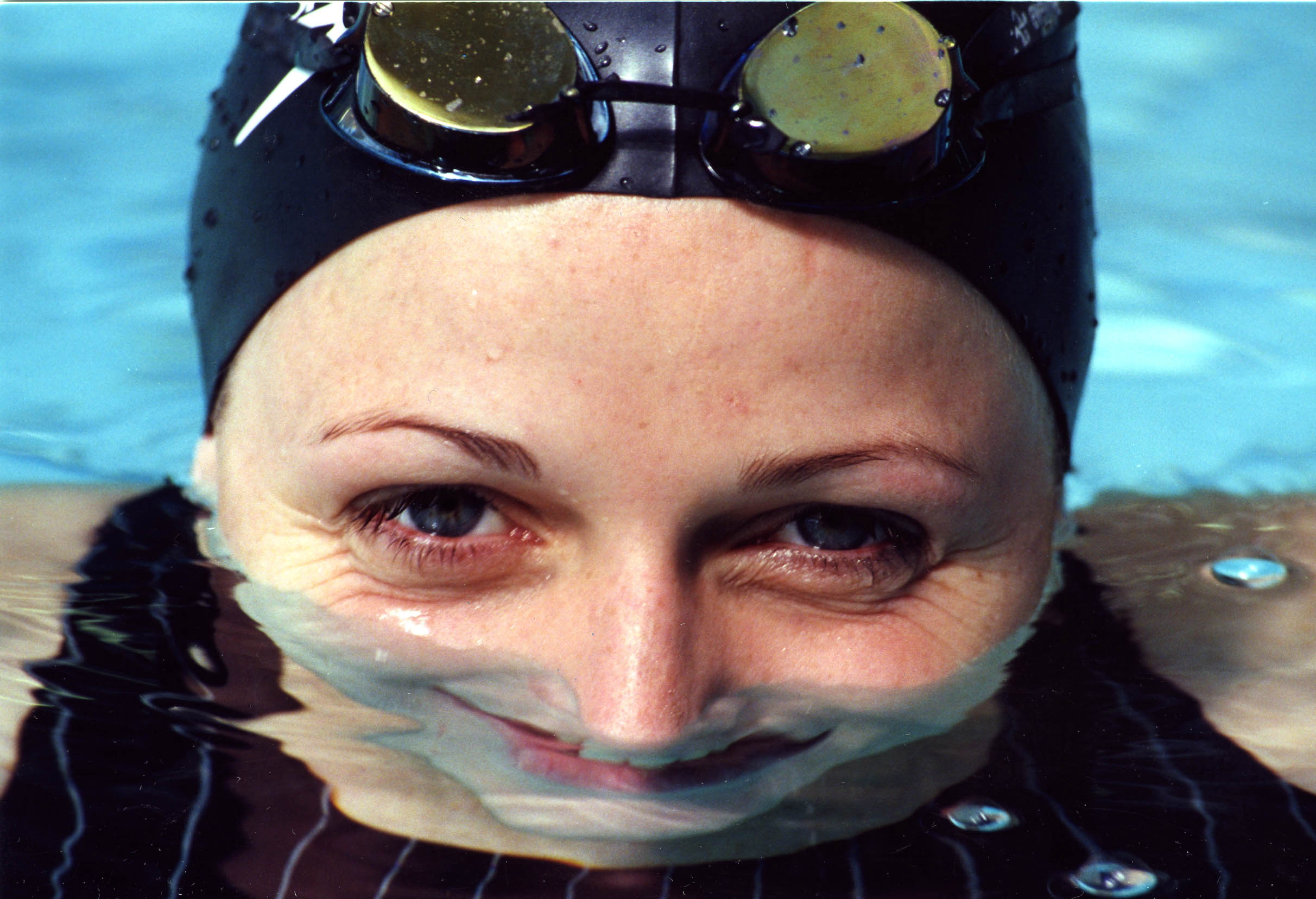 Charlene Wittstock, former Olympic swimmer and current wife of Prince Albert II of Monaco, smiles in a swimming pool on Feb. 10, 1997.