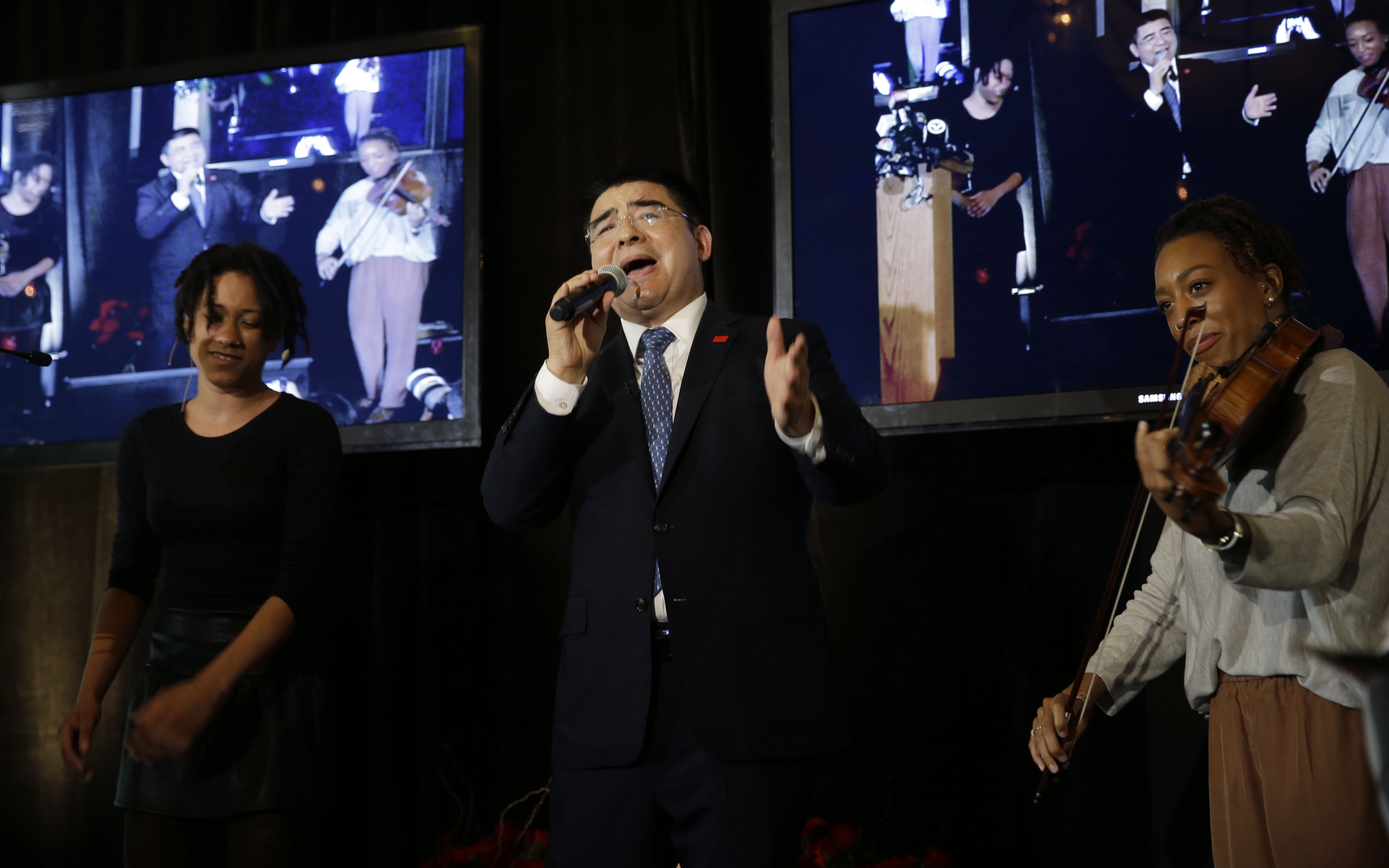 Recycling magnate Chen Guangbiao sings to the media and his guests from the  New York City Rescue Mission at The Loeb Boathouse restaurant in New York, Wednesday, June 25, 2014. The Chinese tycoon known for his sometimes eccentric gestures served up a fancy lunch Wednesday to hundreds of homeless New Yorkers at a Central Park restaurant and serenaded them with "We are the World." Chen said he wants to disprove the cliche image of rich Chinese spending money mostly on luxuries. (AP Photo/Seth Wenig) (Seth Wenig&mdash;ASSOCIATED PRESS)