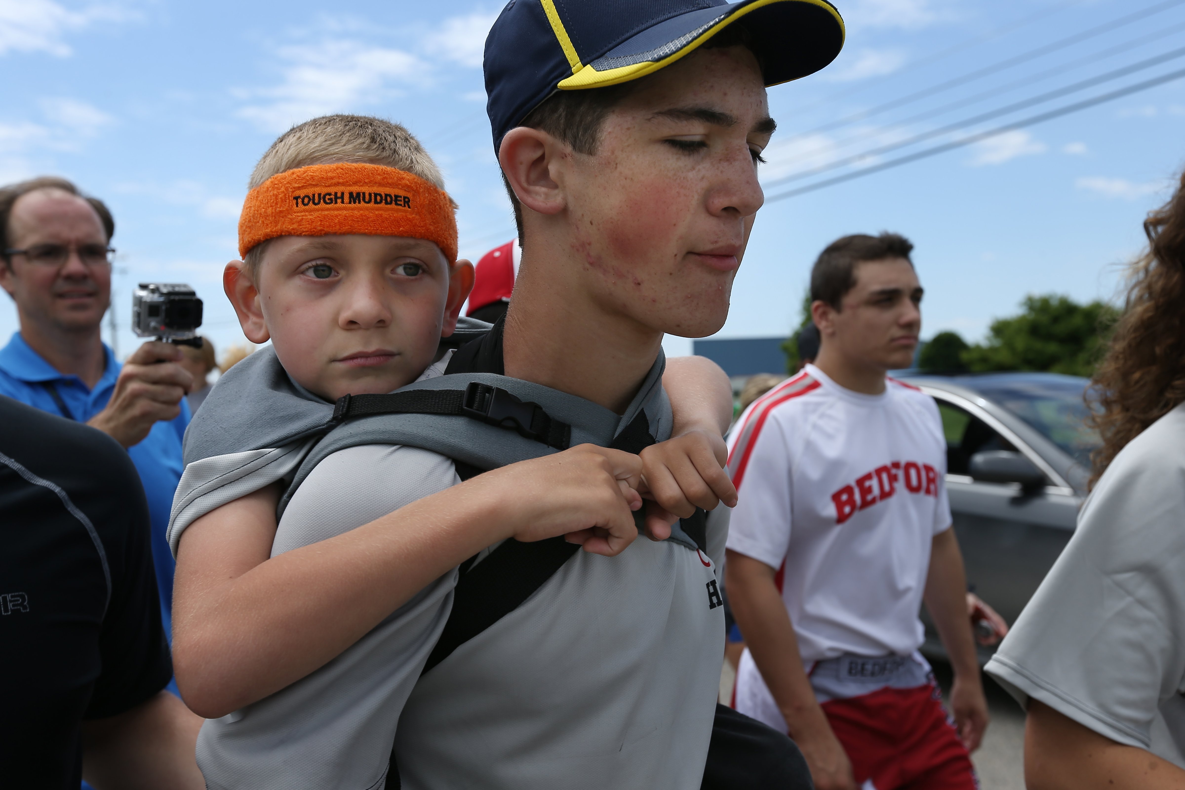 Braden Gandee, 7, rides on the back of his brother Hunter, 14, as they close in on the final miles to the University of Michigan's Bahna Wrestling Center on Sunday, June 8, 2014. Hunter carried Braden, who has cerebral palsy, 40 miles from Temperance, Mich., to Ann Arbor. (Chris Asadian—AP Photo)