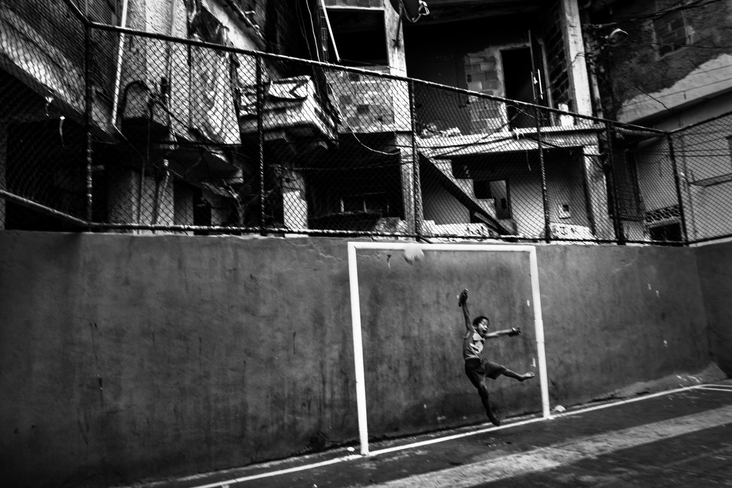 RIO DE JANEIRO, BRAZIL - JUNE 2014: Goalkeeper kid  a training in the soccer school for favela kids in Tavares Bastos favela near Rio´s downtown. (Photo by Sebastián Liste/ Reportage by Getty Images)