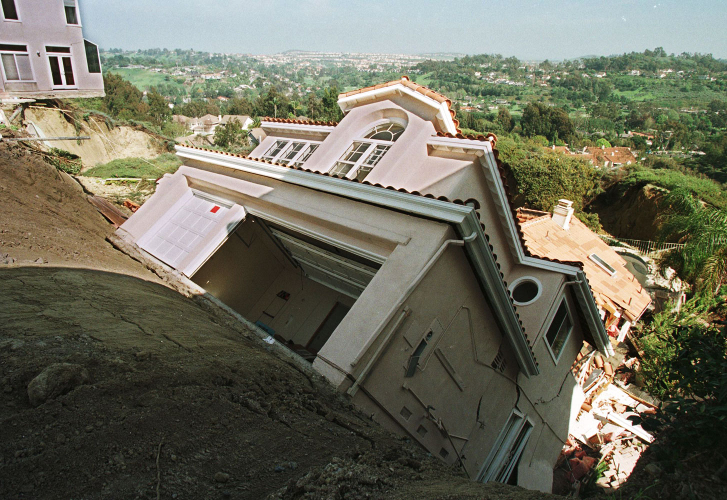 A luxury home in Laguna Niguel Calif. slips down a hillside eroded on March 19, 1998 by heavy El Nino generated rains. Two homes and seven condominiums have been destroyed in the slide and several more were threatened with destruction.
