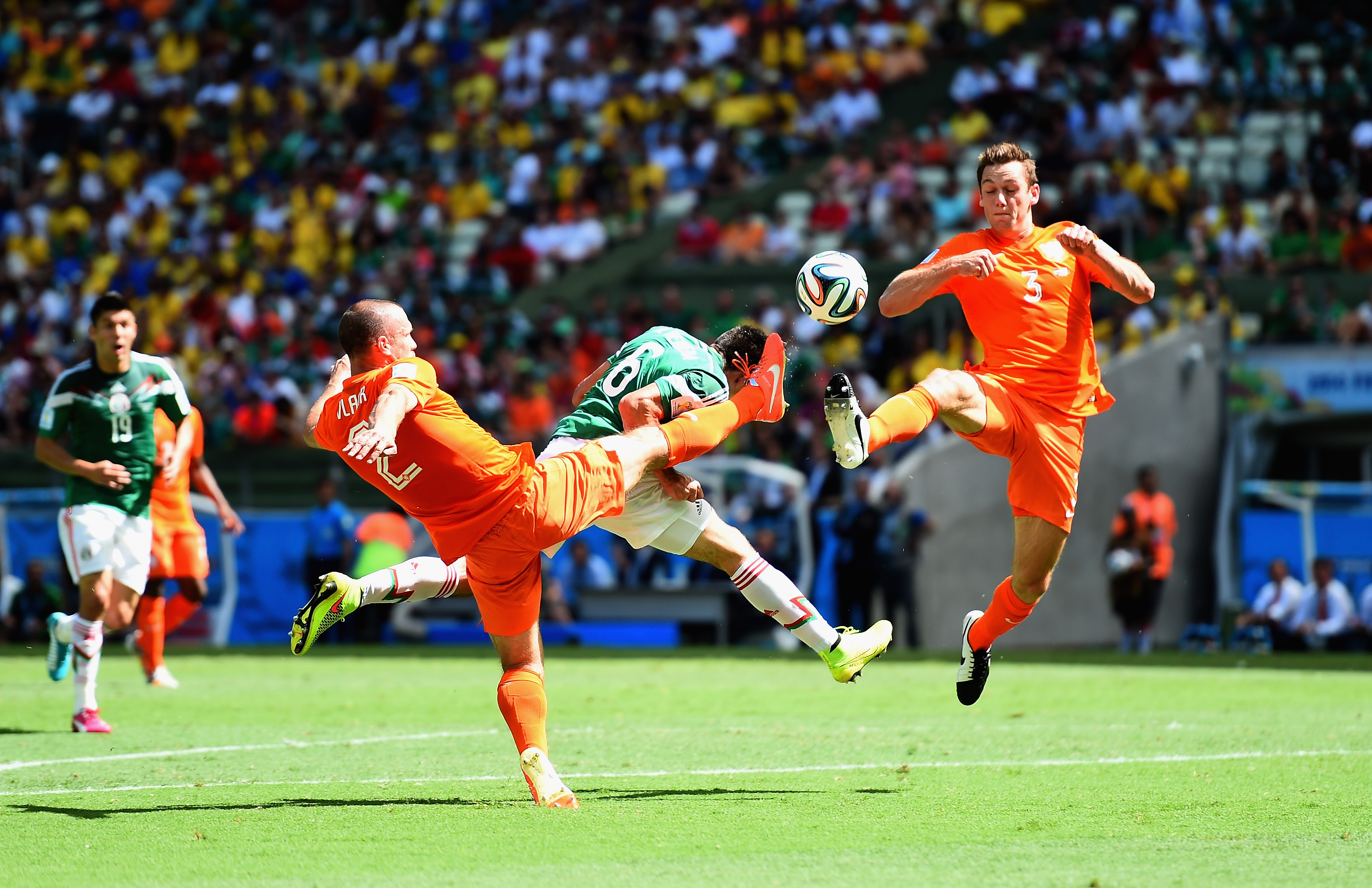 Ron Vlaar and Stefan De Vrij of Netherlands battles with Hector Herrera of Mexico during the 2014 FIFA World Cup on June 29 in Fortaleza, Brazil. (Laurence Griffiths—Getty Images)