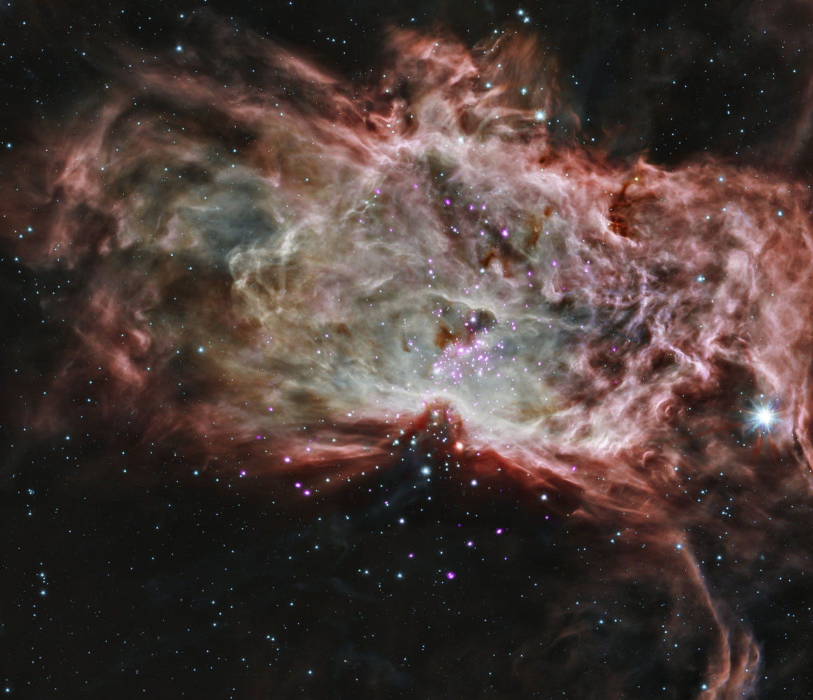 NGC 2024, found in the center of the Flame Nebula which is about 1,400 light years from Earth is shown in this composite image released on May 7, 2014.
