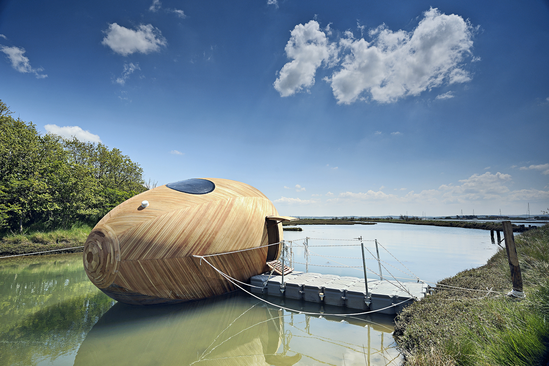 Artist Stephen Turner has spent a full year living aboard the experimental dwelling he built, which floats along southern England’s Beaulieu River. Its wooden exterior is tethered to the shore like a boat and houses a bed, worktable, kitchen and bathroom.