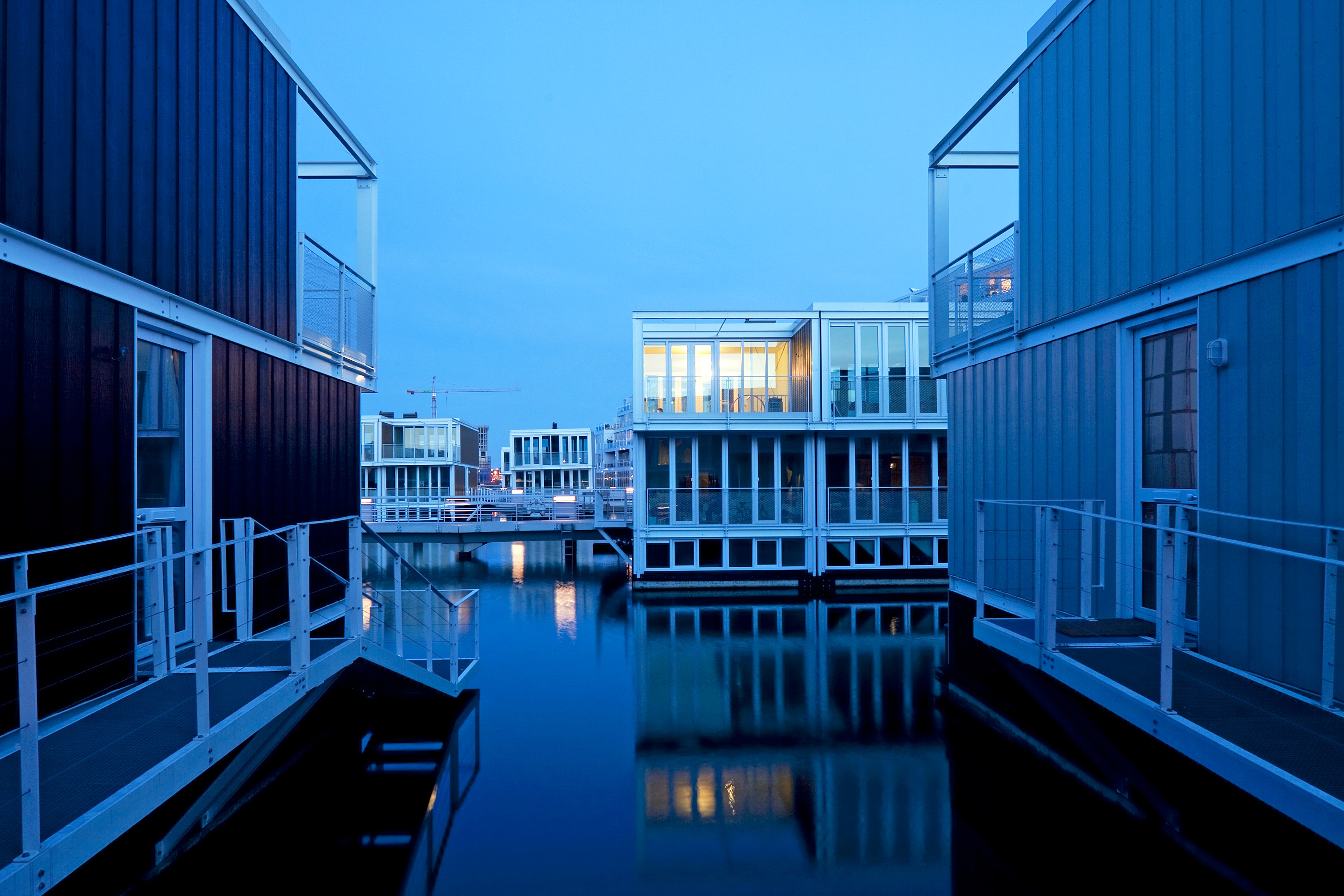 Fifty-five homes float in the IJburg district in east Amsterdam. The structures, designed by  the Dutch firm Marlies Rohmer Architects, sit on hollow concrete "tubs" that are submerged half a story. (Luuk Kramer)