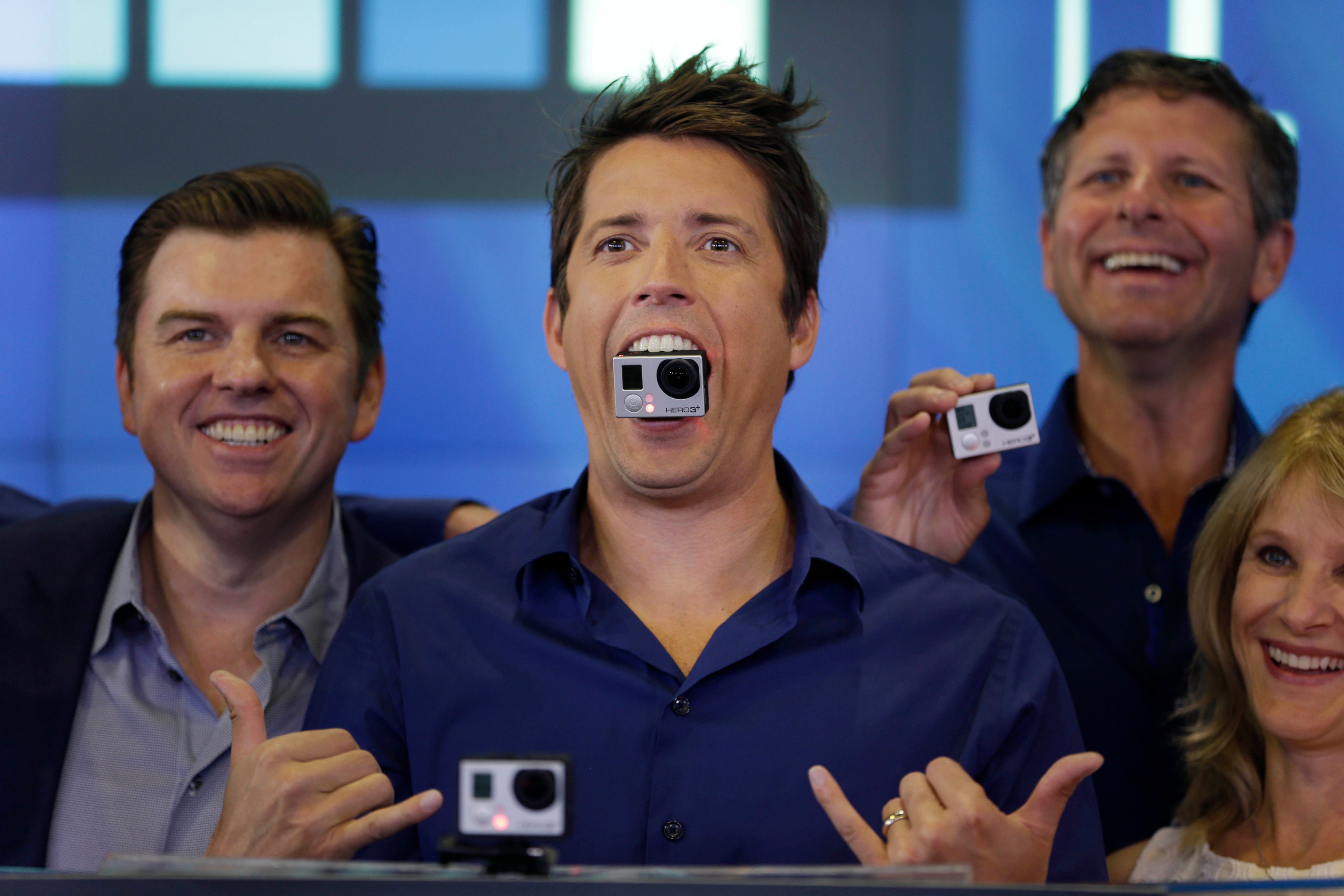 GoPro's CEO Nick Woodman holds a GoPro camera in his mouth as he celebrates his company's IPO at the Nasdaq MarketSite in New York, June 26, 2014. (Seth Wenig—AP)