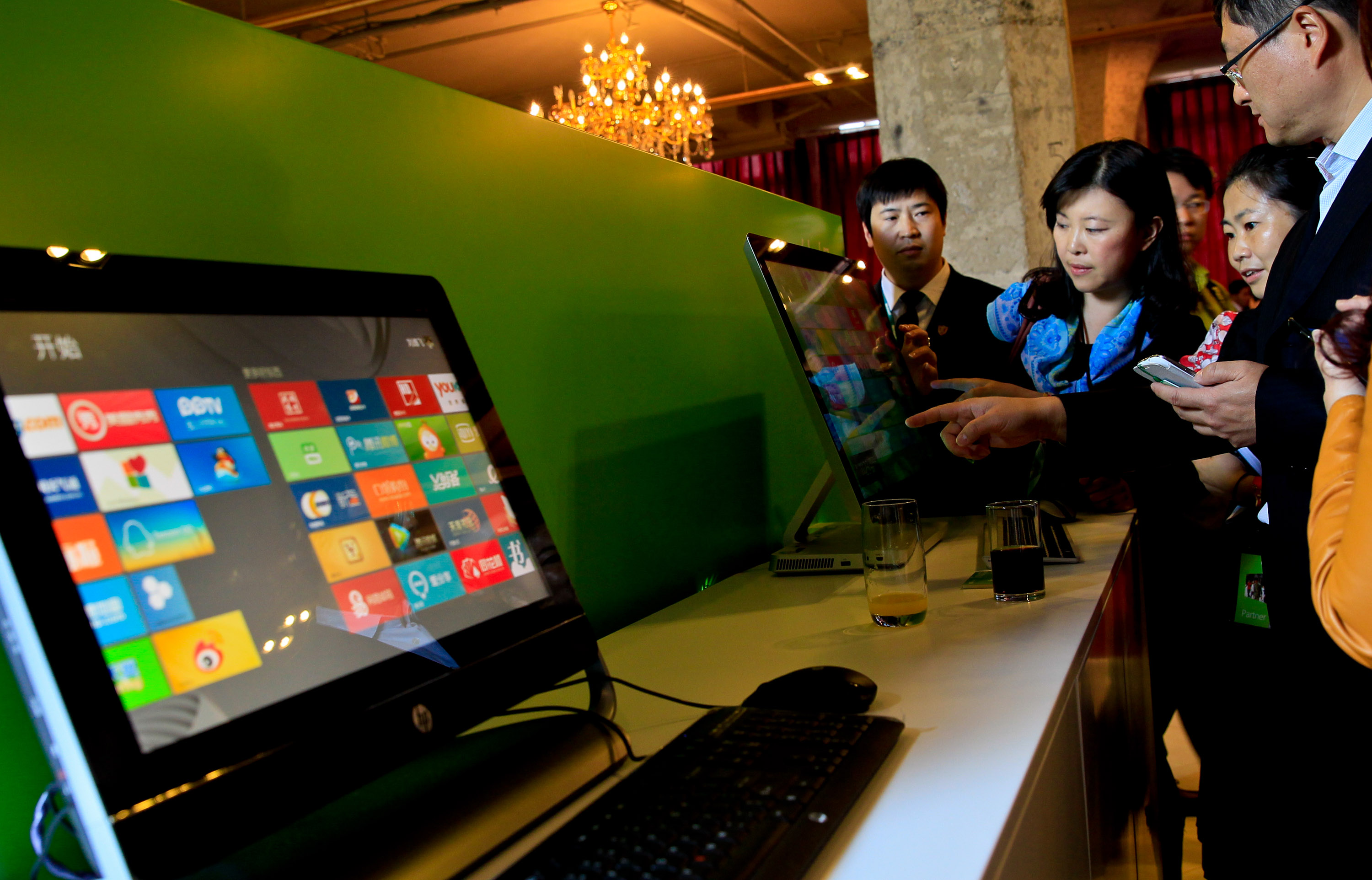 Guests try out the Microsoft Windows 8 operation system on touchable screens of desktop computers during the preview show of the new operation system and tablet computer Surface in Shanghai, China, Oct. 23, 2012. (An Tu—EPA)