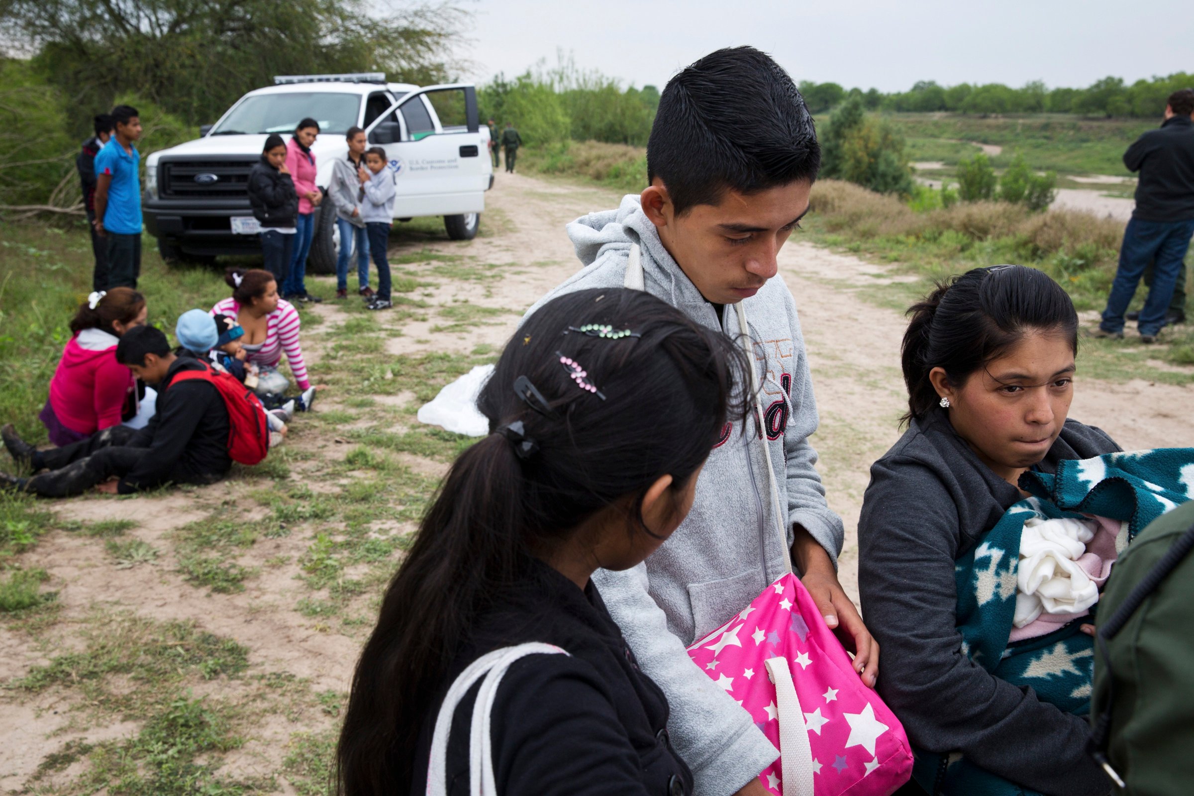 U.S. Border Patrol agents detain a group of young migrants from Honduras and Guatemala near the Anzalduas Dam.