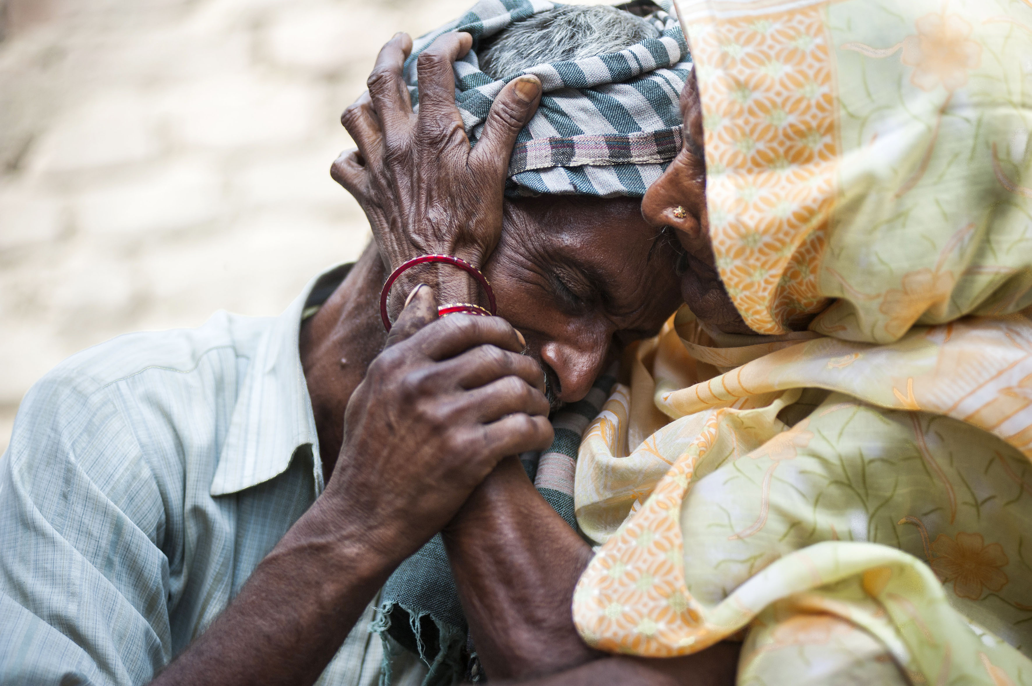 Sohan Lal (55) father of raped and murdered daughter Murti weeps and is comforted by his mother Ramkali in Katra Sadatganj village, Uttar Pradesh, India on May 30, 2014.