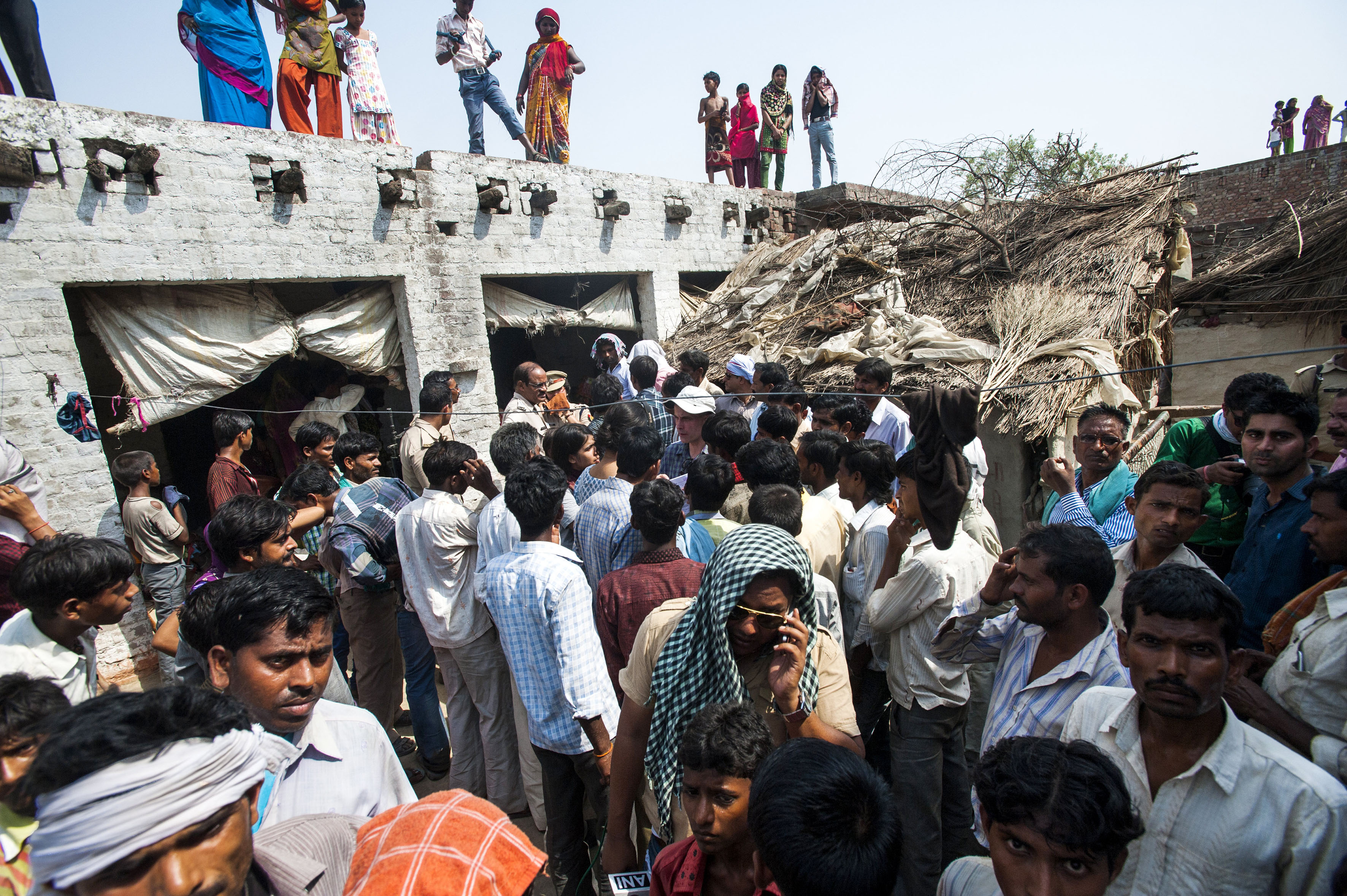 Villagers and media throng the home of the teenage girls raped and murdered in Katra Sadatganj village, Uttar Pradesh, India on May 30, 2014.