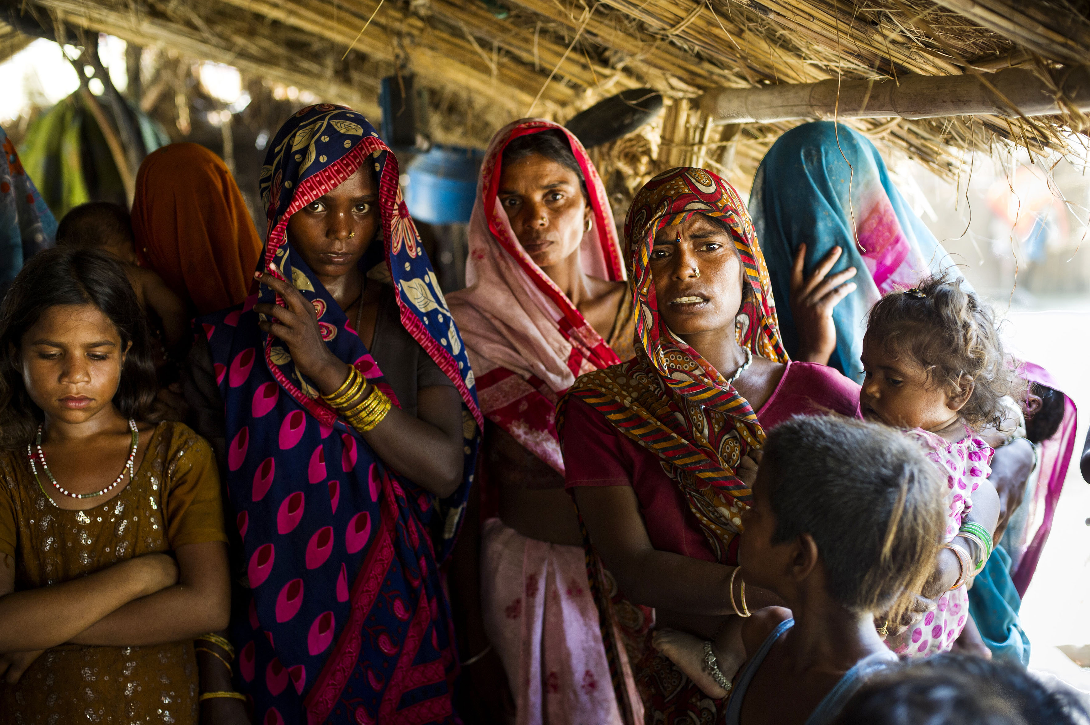 Mira (right, holding daughter) speaks about the victims in Katra Sadatganj village, Uttar Pradesh, India on May 30, 2014.