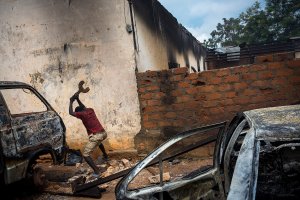 Central African RepublicBanguiA Christian man is destroying burn out cars in rage, next to a looted mosque that was set on fire earlier, in the capital Bangui.