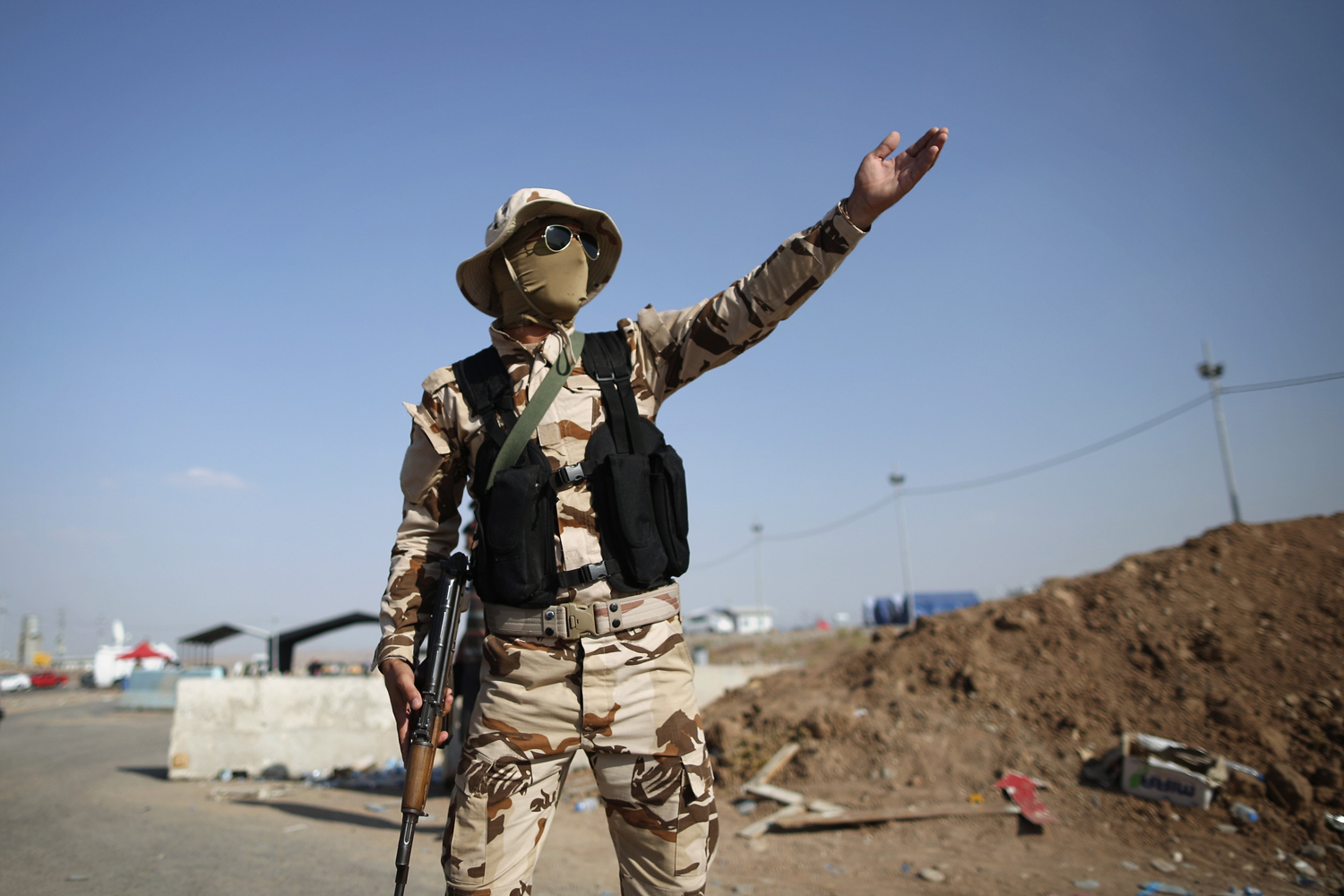 Peshmerga military direct traffic at a Kurdish check point on June 14, in Kalak.