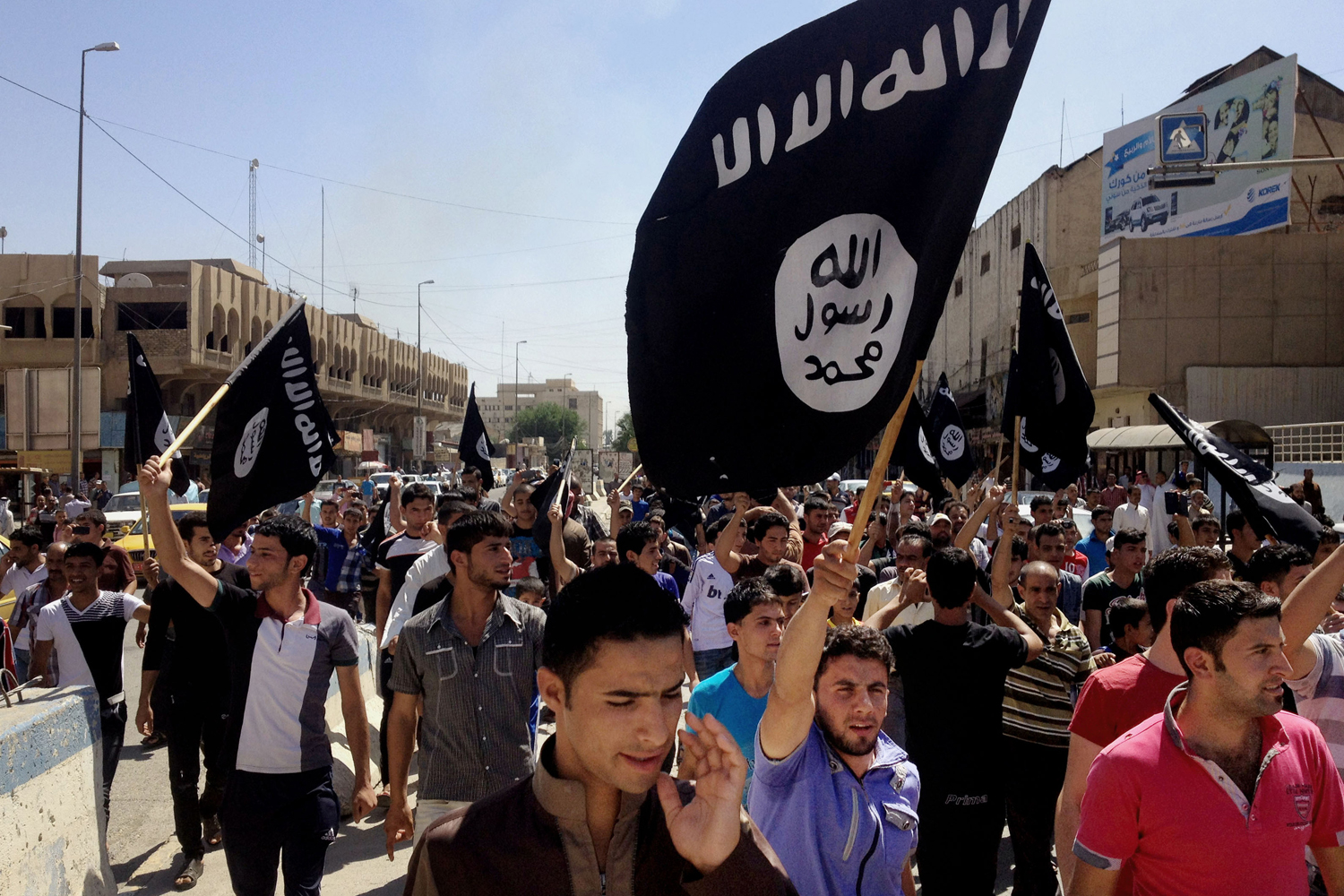 Demonstrators chant Islamic State of Iraq and Syria (ISIS) in front of the provincial government headquarters in Mosul, June 16, 2014.