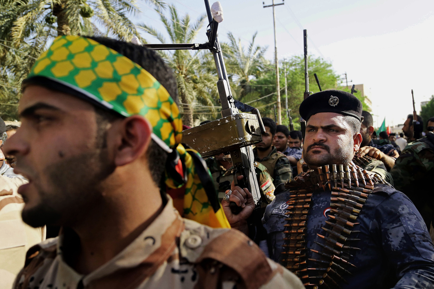 Shiite tribal fighters raise their weapons and chant slogans against the al-Qaida-inspired Islamic State of Iraq and Syria (ISIS) in Basra, June 16.